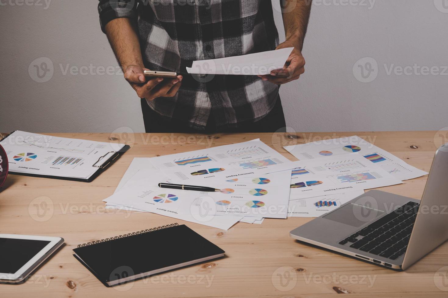 Gros plan d'homme d'affaires travaillant avec des diagrammes de stratégie sur un bureau en bois au bureau photo