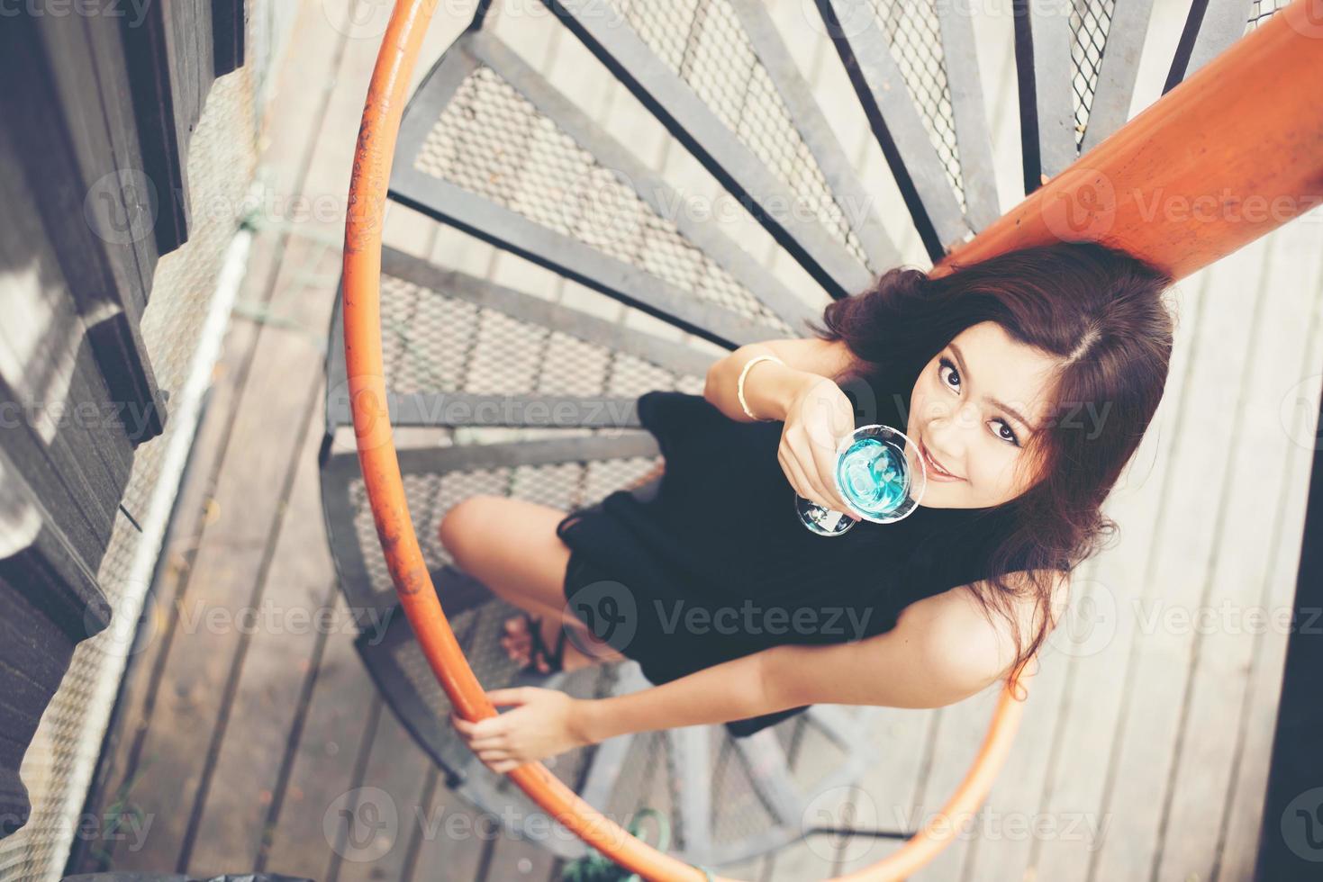 Portrait d'une jeune femme heureuse s'amuser et boire un cocktail photo