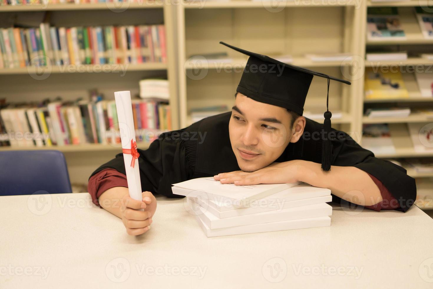heureux étudiant diplômé tenant un diplôme en main photo