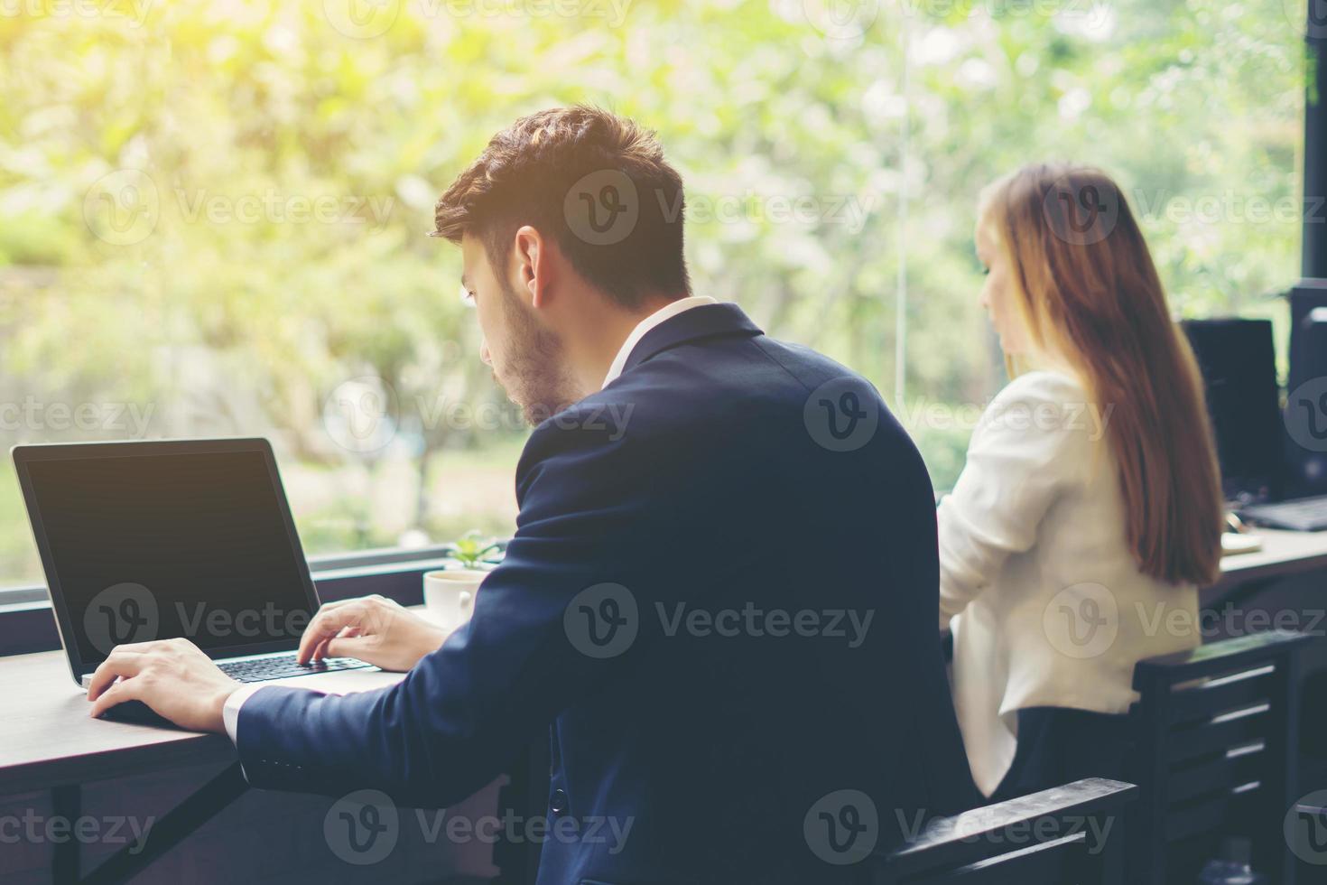 jeune homme d'affaires travaillant sur ordinateur portable au bureau photo