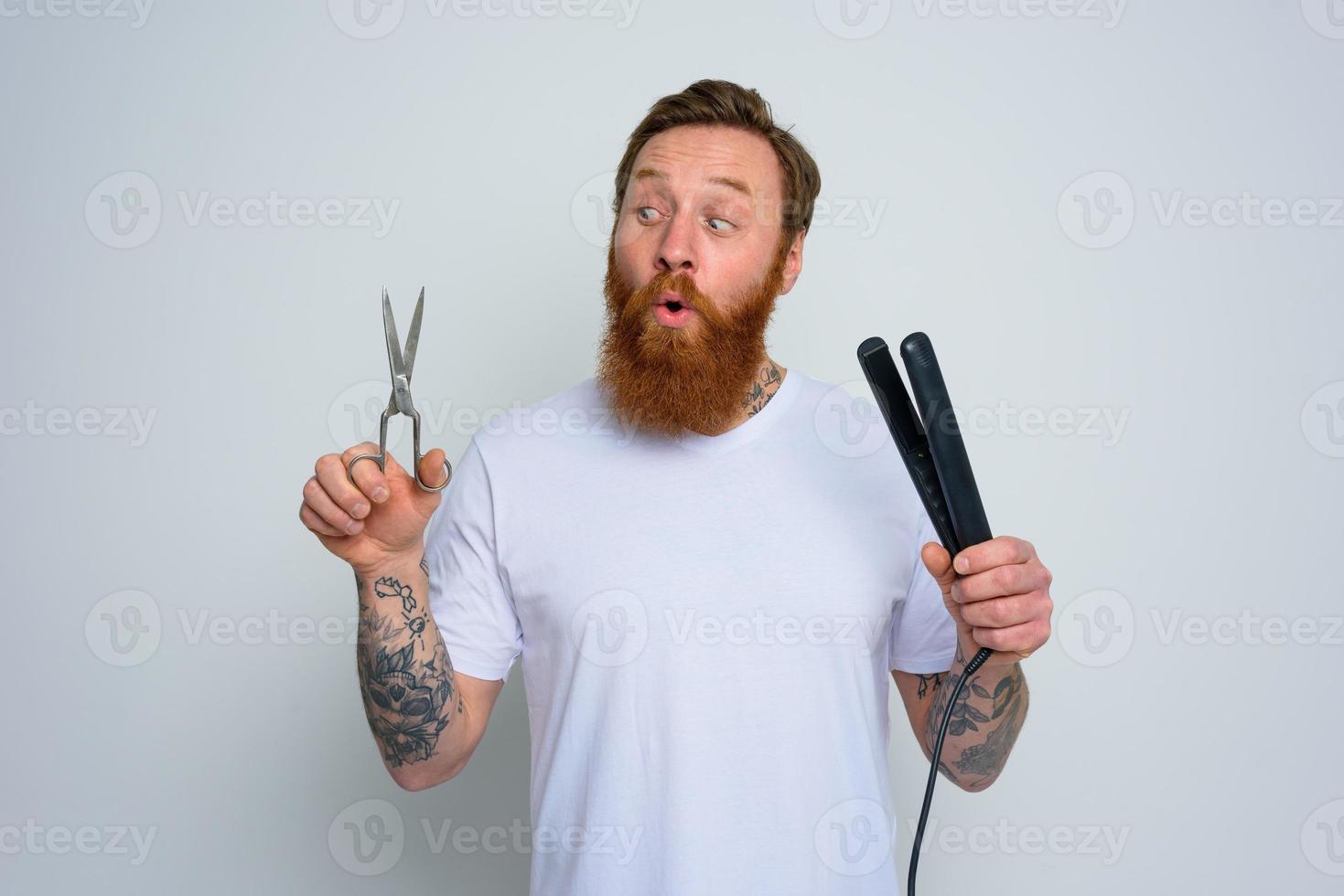 demandé homme avec les ciseaux et lisseur est prêt à travail avec cheveux photo