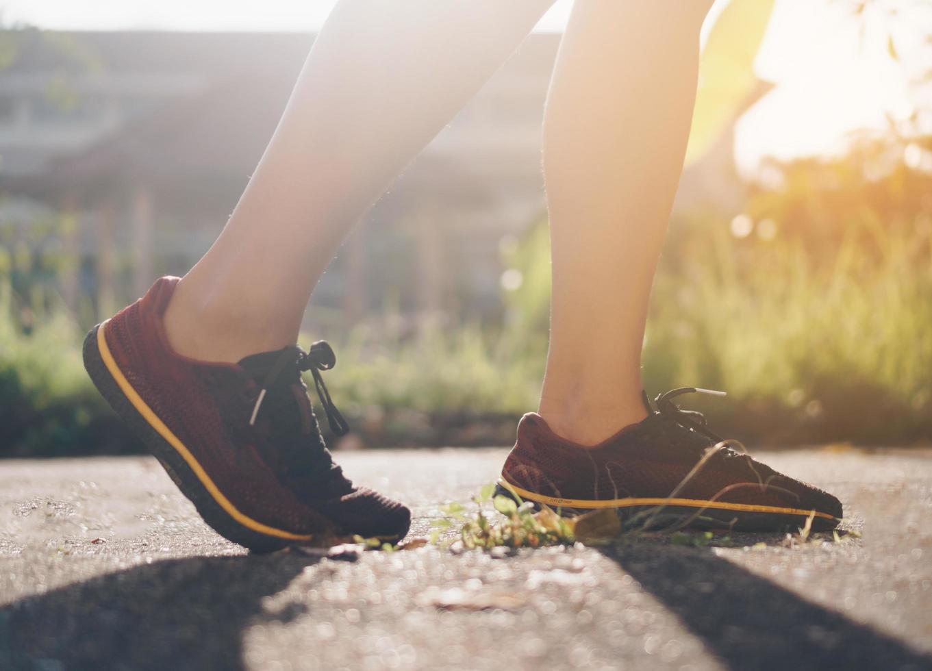 femme porter des chaussures de course et courir sur fond vert nature photo