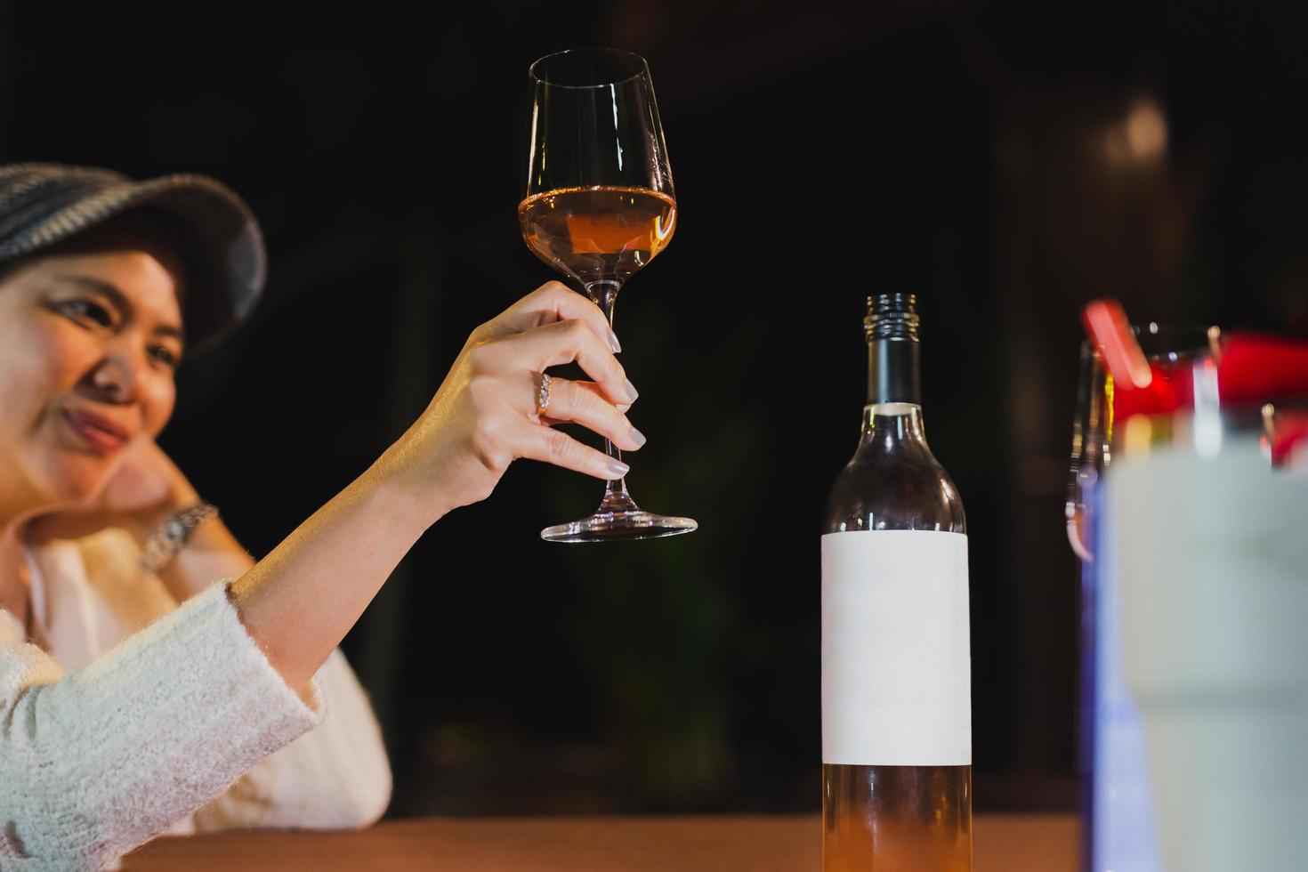 content femme en portant verre de du vin relaxant dans restaurant. photo