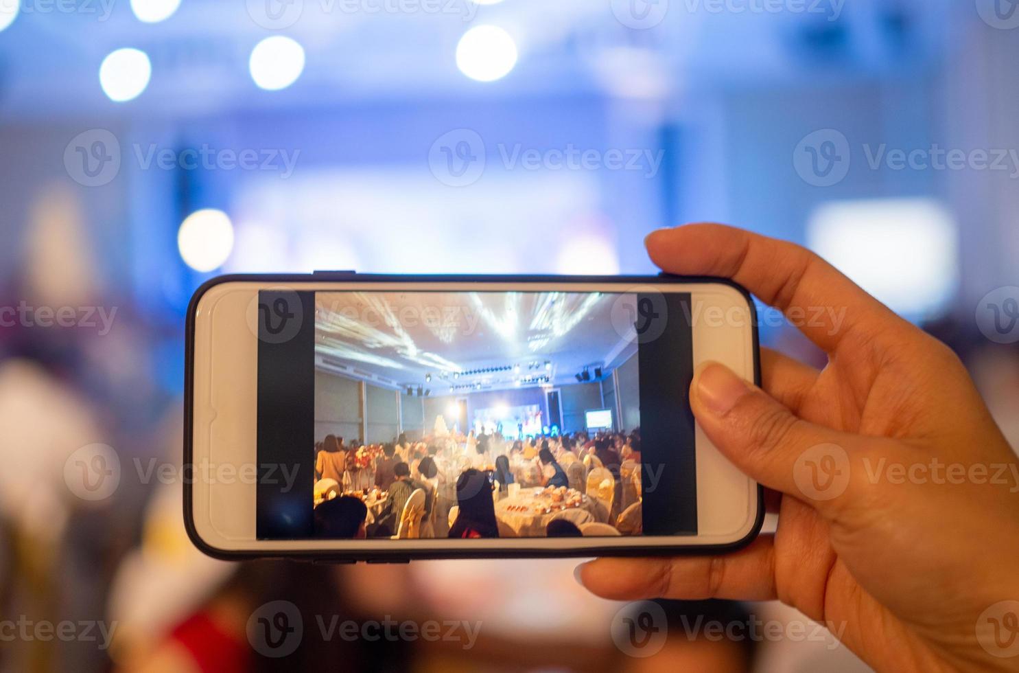 une photo de une femme main pris à le mariage la cérémonie avec une mobile téléphone.