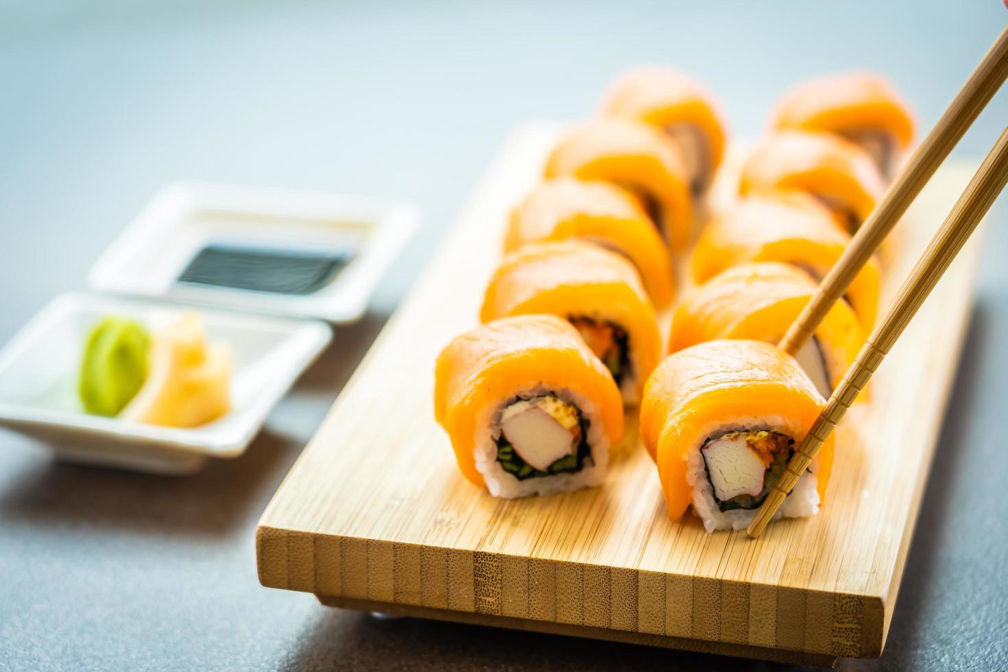 Rouleaux de sushi au saumon sur plaque de bois photo