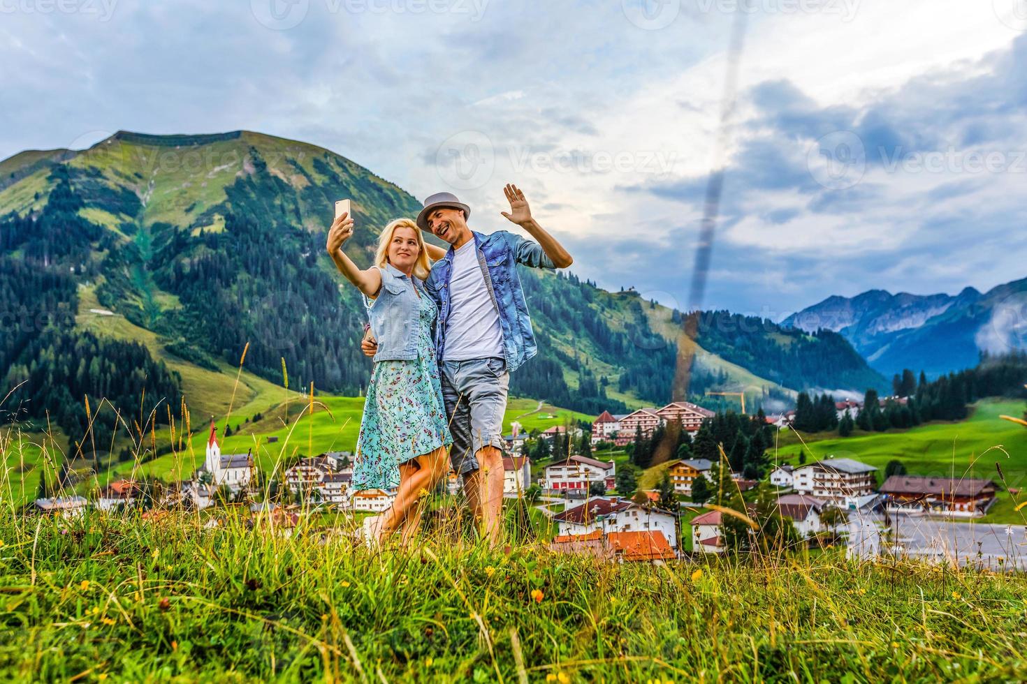 Jeune couple dans montagnes souriant photo