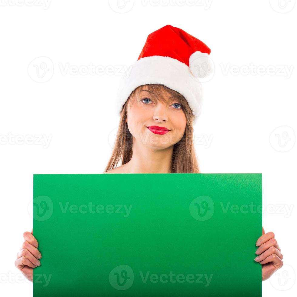 souriant Noël fille avec vert placard sur blanc photo