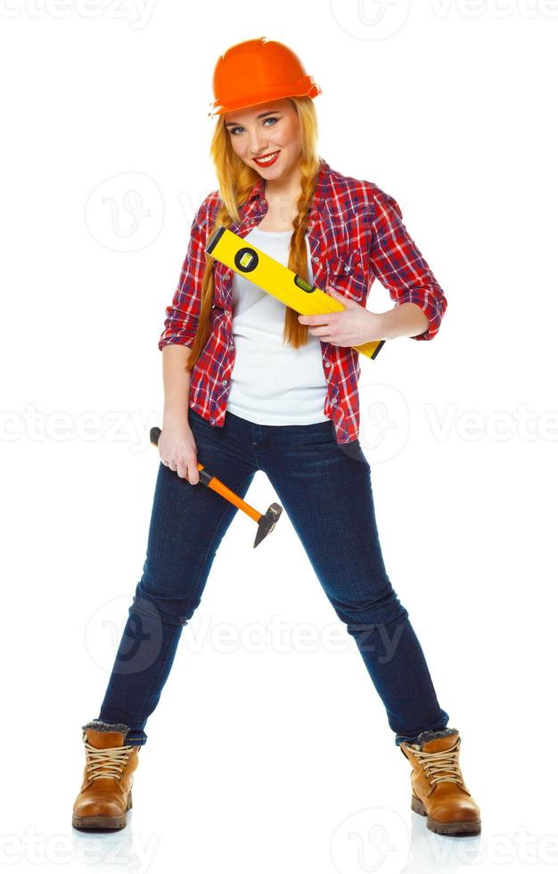 Jeune femme dans casque avec le travail outils sur une blanc photo