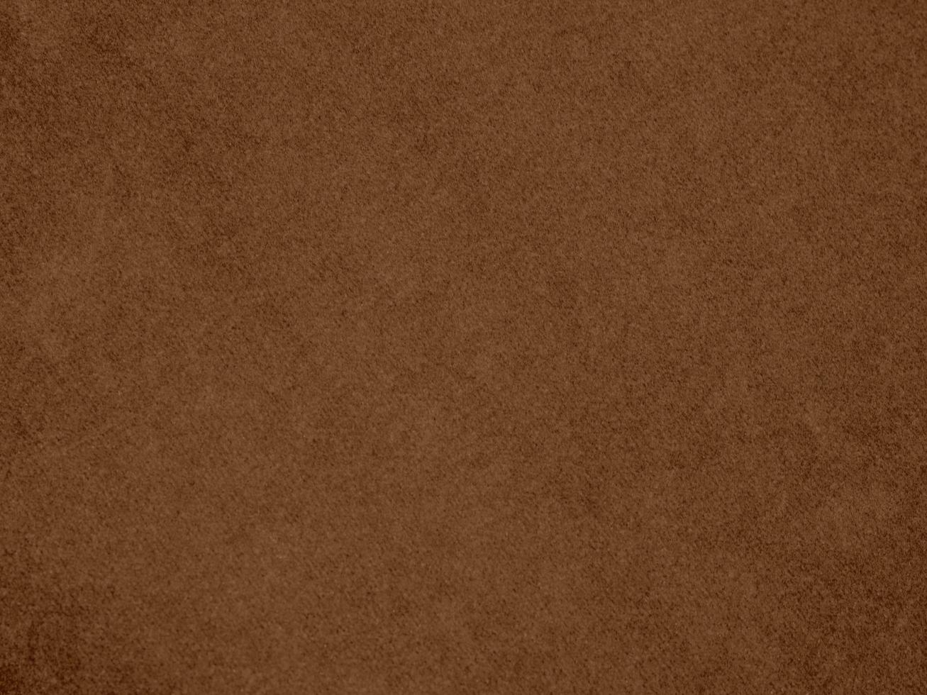 texture de tissu de velours de couleur marron utilisée comme arrière-plan. fond de tissu marron vide de matière textile douce et lisse. il y a de l'espace pour le texte. photo