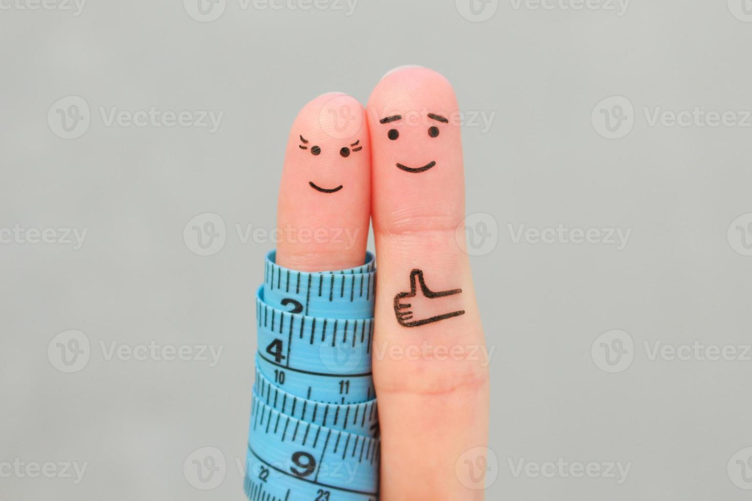 les doigts art de une content couple avec ruban mesure. concept de perdant poids ensemble. photo