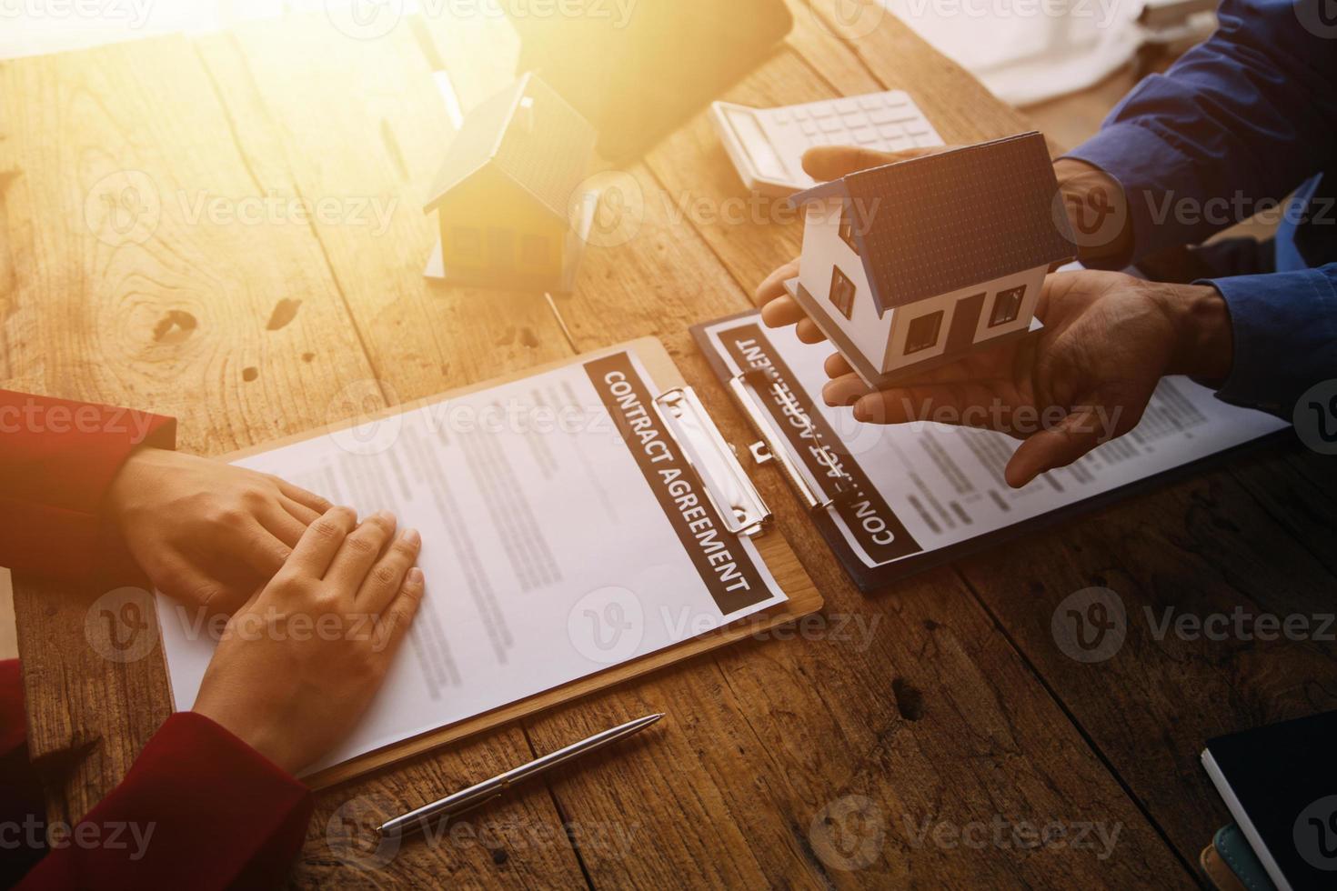 agent de courtage immobilier présentant et consultant le client pour la prise de décision signant un accord de formulaire d'assurance, modèle d'achat et de vente de maison, concernant l'offre de prêt hypothécaire et l'assurance habitation photo