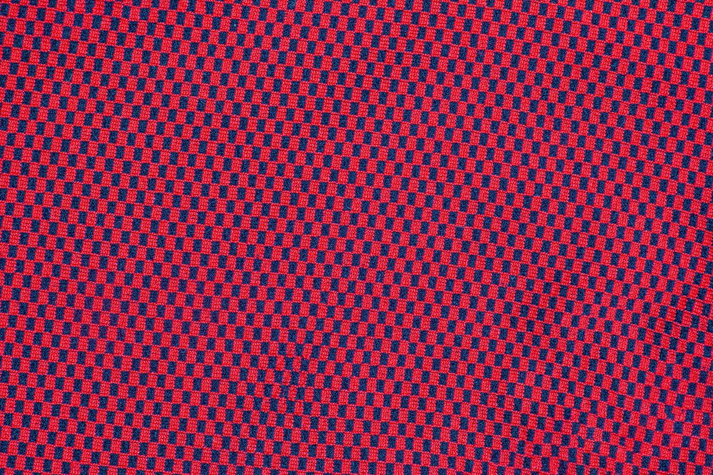 synthétique en tissu texture, rouge plaid, magnifique Contexte modèle. fragment de thermique sous-vêtements tissu. photo