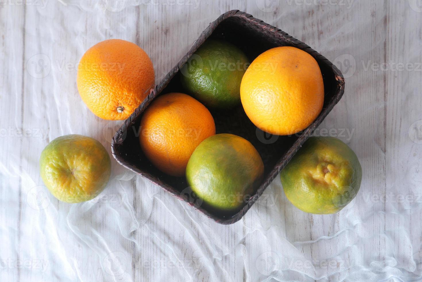 Vue de dessus des oranges dans un bol sur fond neutre photo