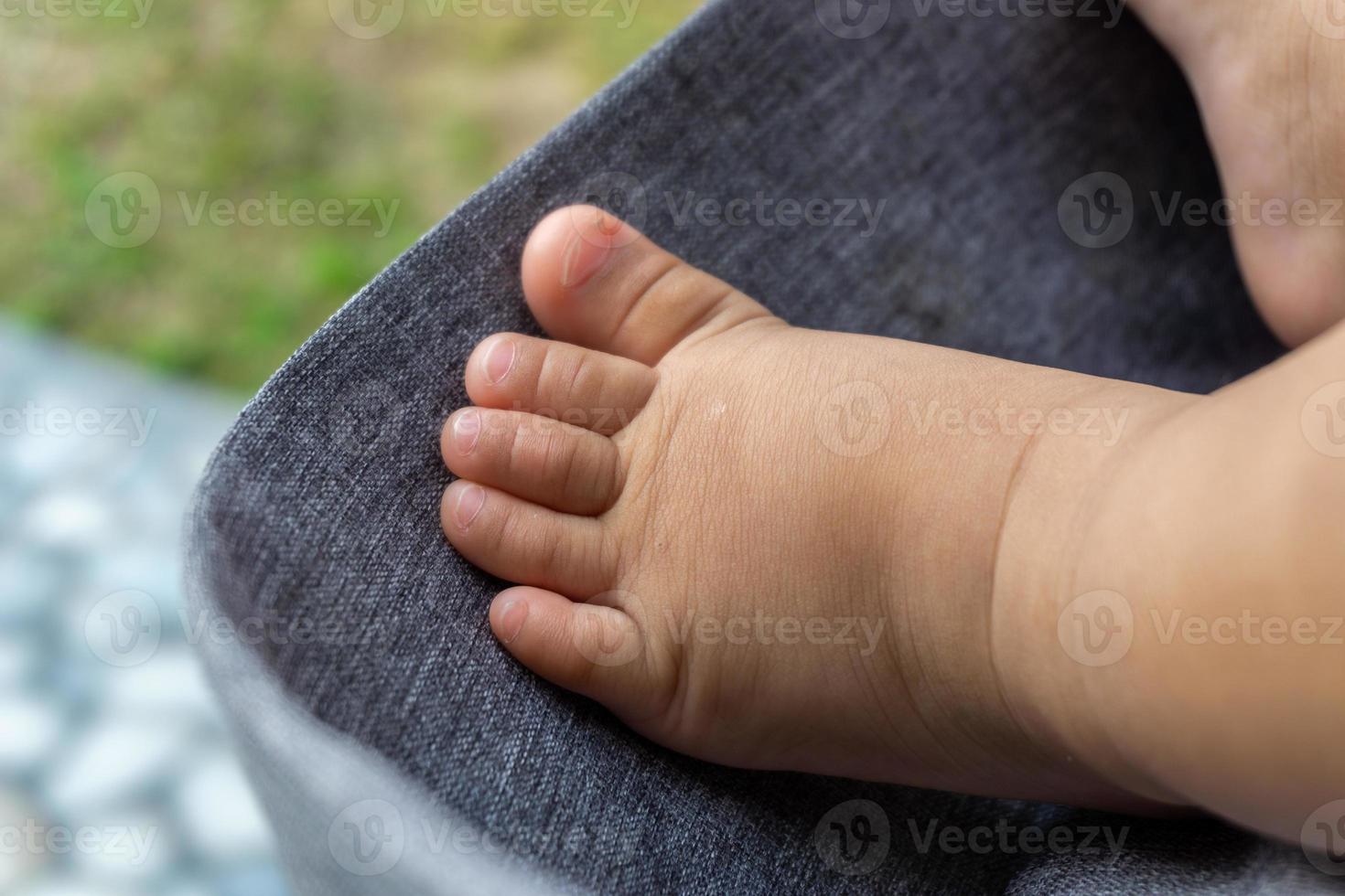 proche en haut de bébé minuscule pieds. bébé pied sur poussette. bébé garçon minuscule pieds. photo
