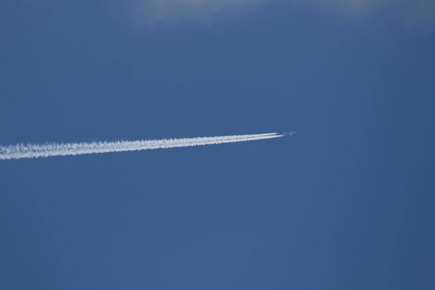 un avion et des traînées de vapeur dans le ciel photo