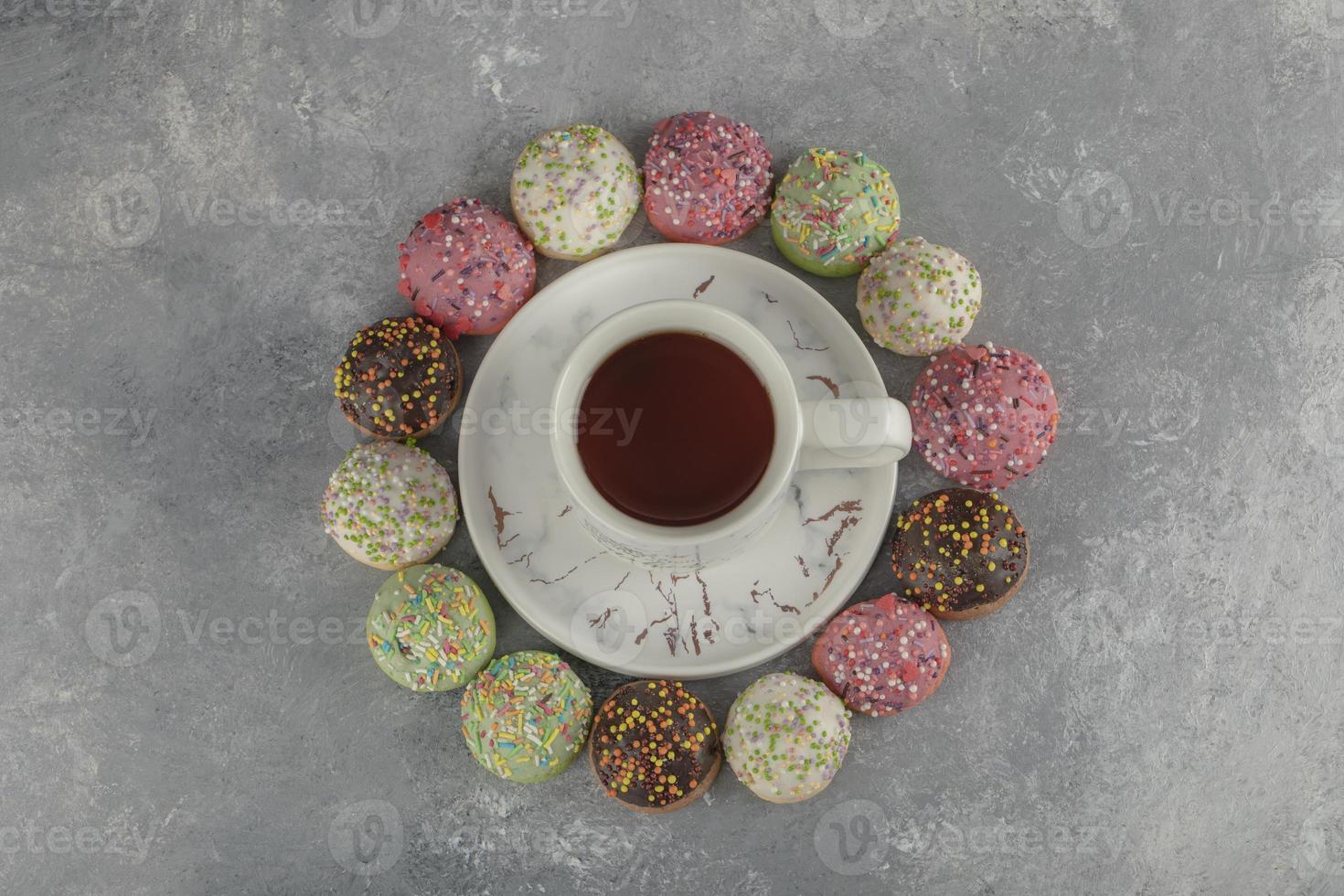 beignets sucrés colorés avec une tasse de thé photo