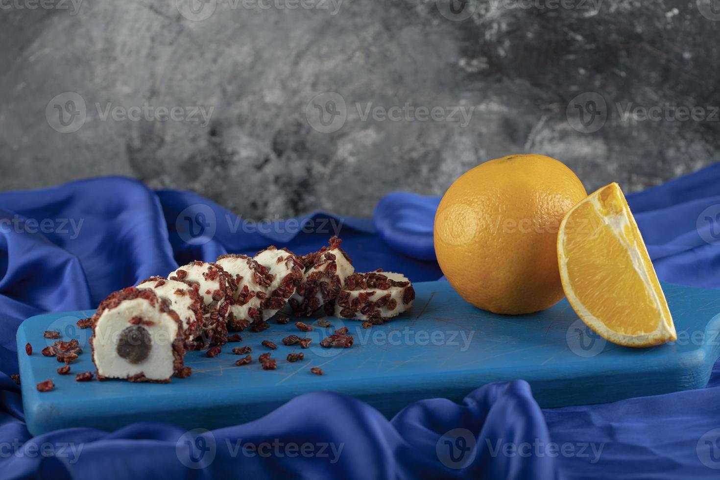 Dessert en tranches sucré avec des fruits secs sur une planche bleue en bois photo