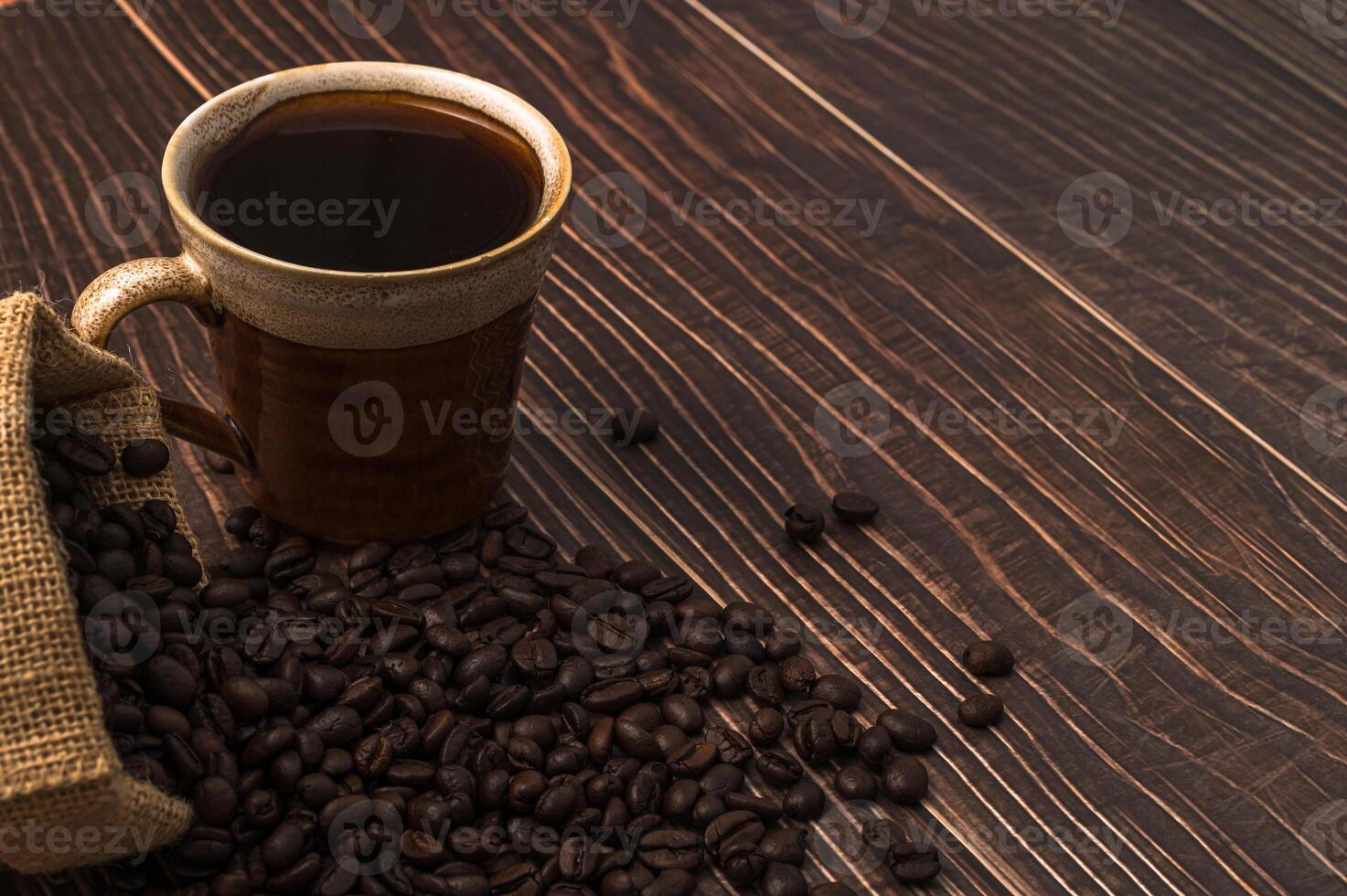 Une tasse de café et des grains de café sur une table en bois, concept de café d'amour photo