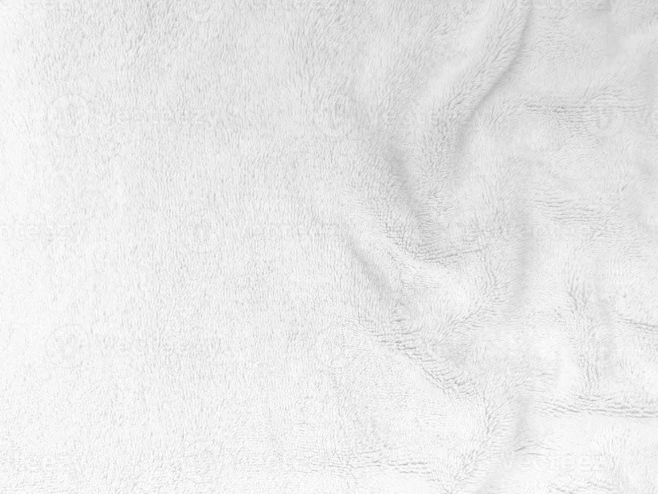 fond de texture de laine propre blanche. laine de mouton naturelle légère. coton blanc sans couture. texture de fourrure moelleuse pour les concepteurs. gros plan fragment de tapis de laine blanche. photo