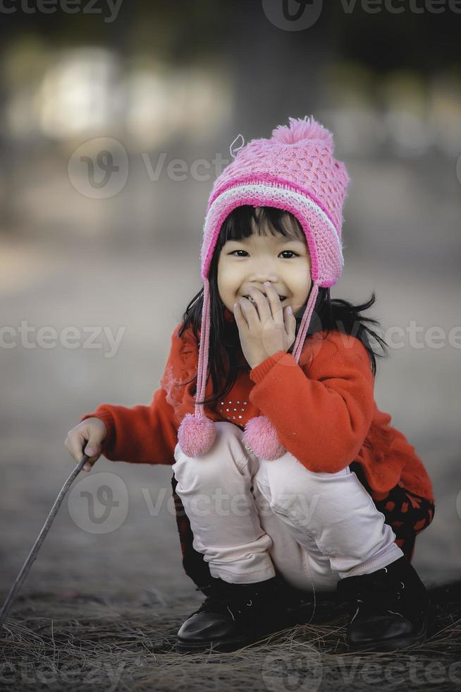 portrait de mignonne asiatique peu fille porter hiver vêtements à le forêt de le parc, Thaïlande gens pose pour prendre une image, heureux temps photo