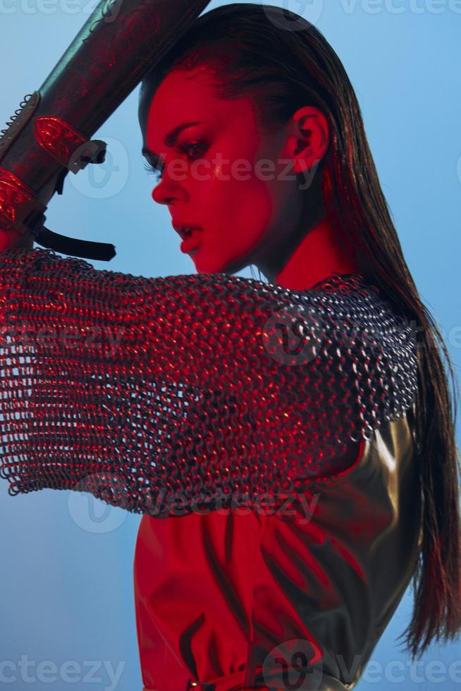 photo jolie femme charme posant rouge lumière métal armure sur main inchangé