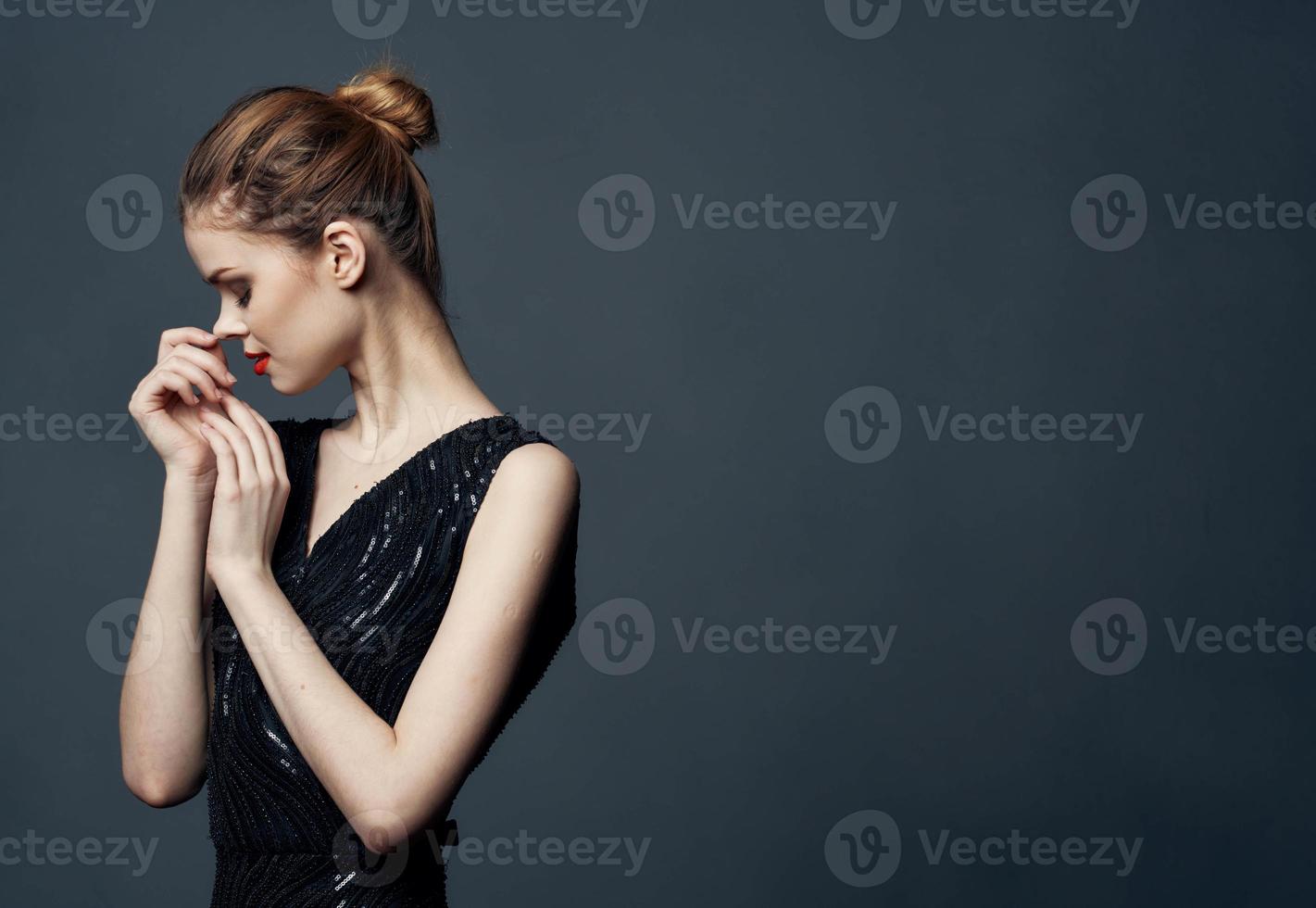 femme dans noir robe sur gris Contexte tondu vue de maquillage coiffure modèle photo