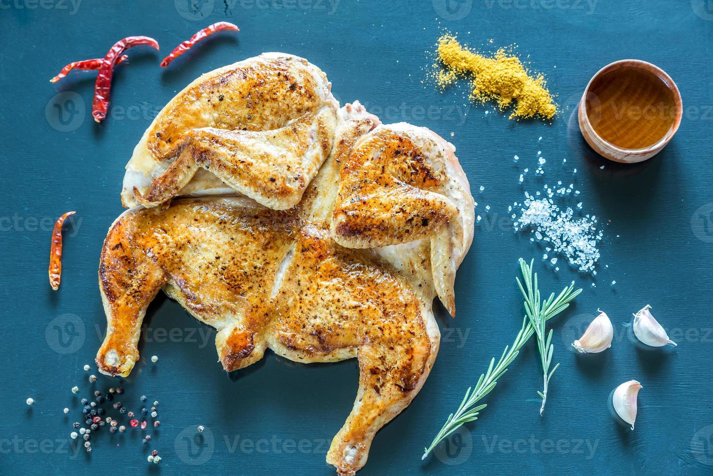 poulet grillé avec des ingrédients sur le fond en bois foncé photo