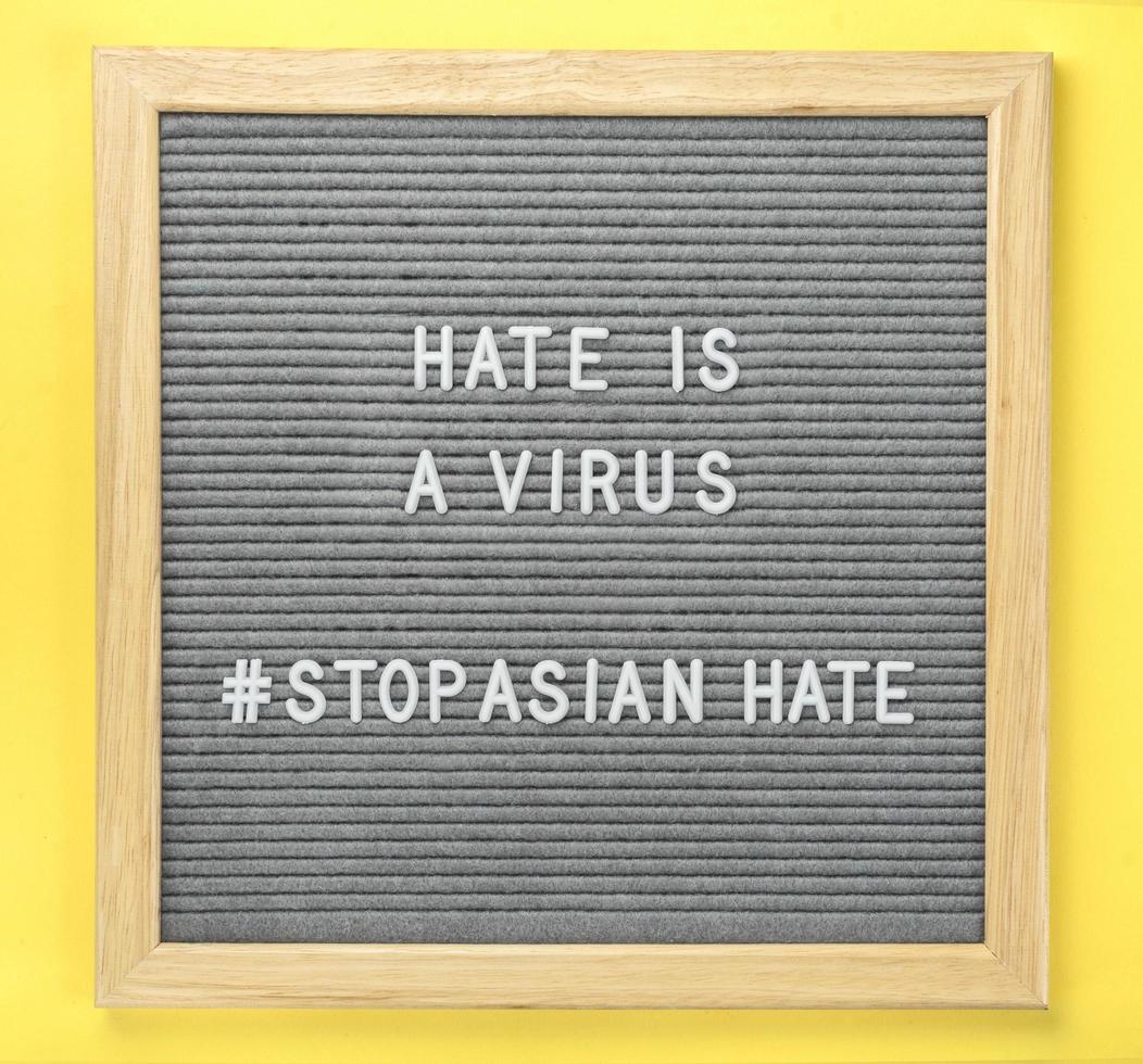 Letterboard with quote hate is a virus and hashtag stop Asian hate photo