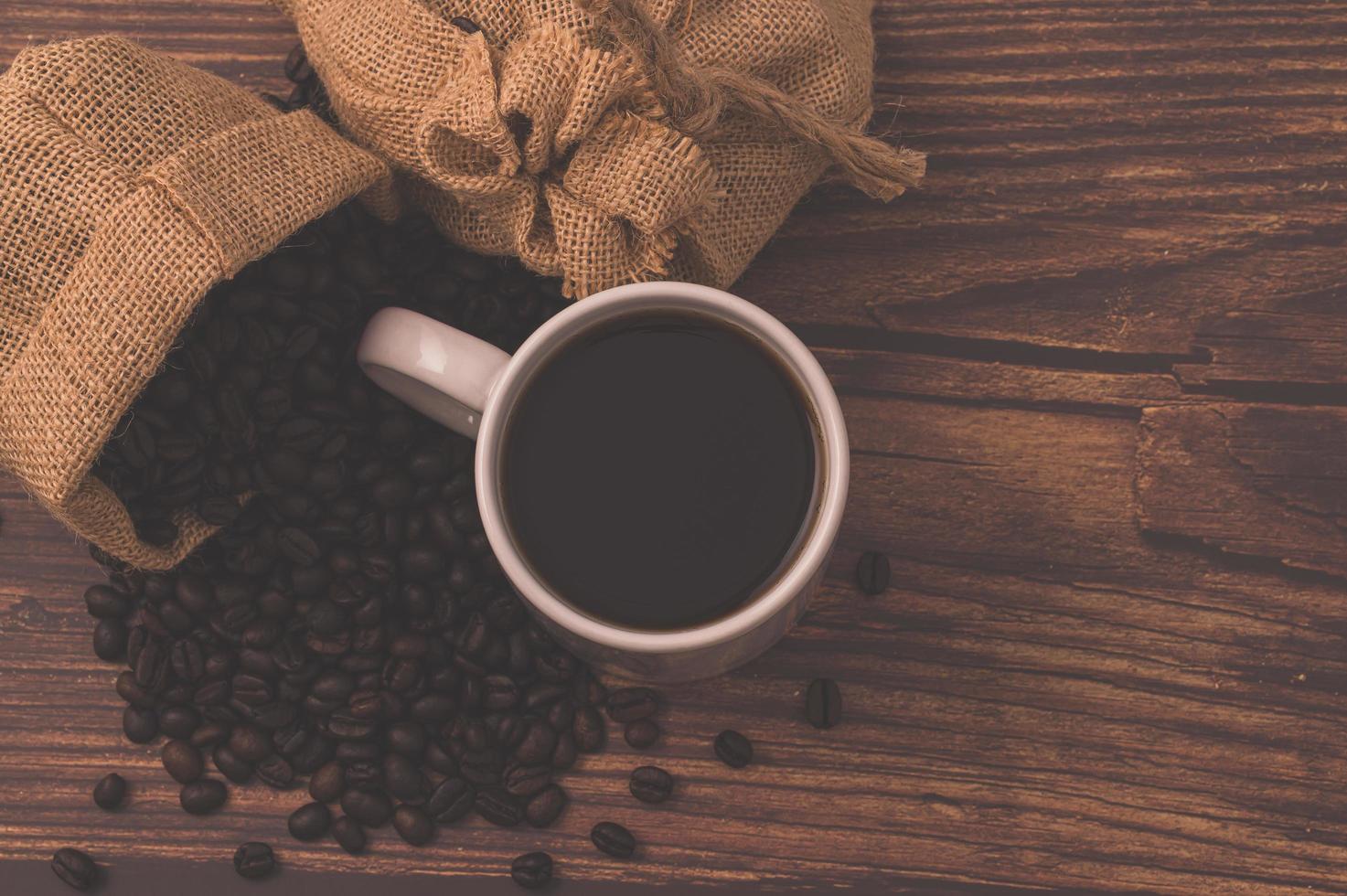 aime boire du café, des grains de café sur la table photo