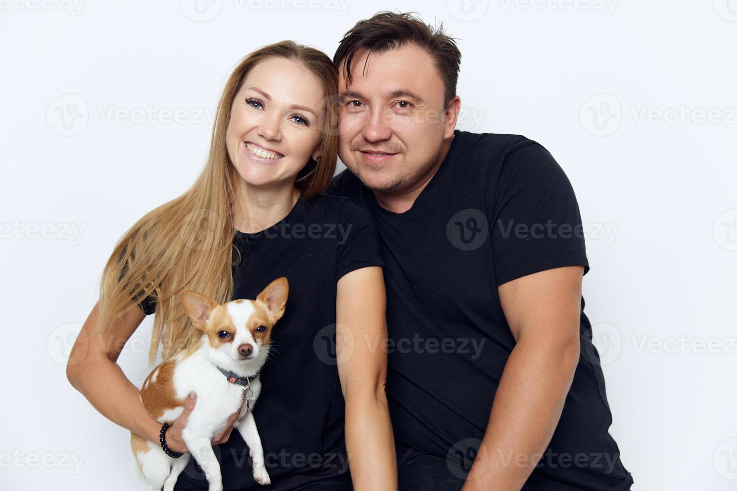 de bonne humeur marié couple câlins noir t-shirts studio petit chien dans mains photo