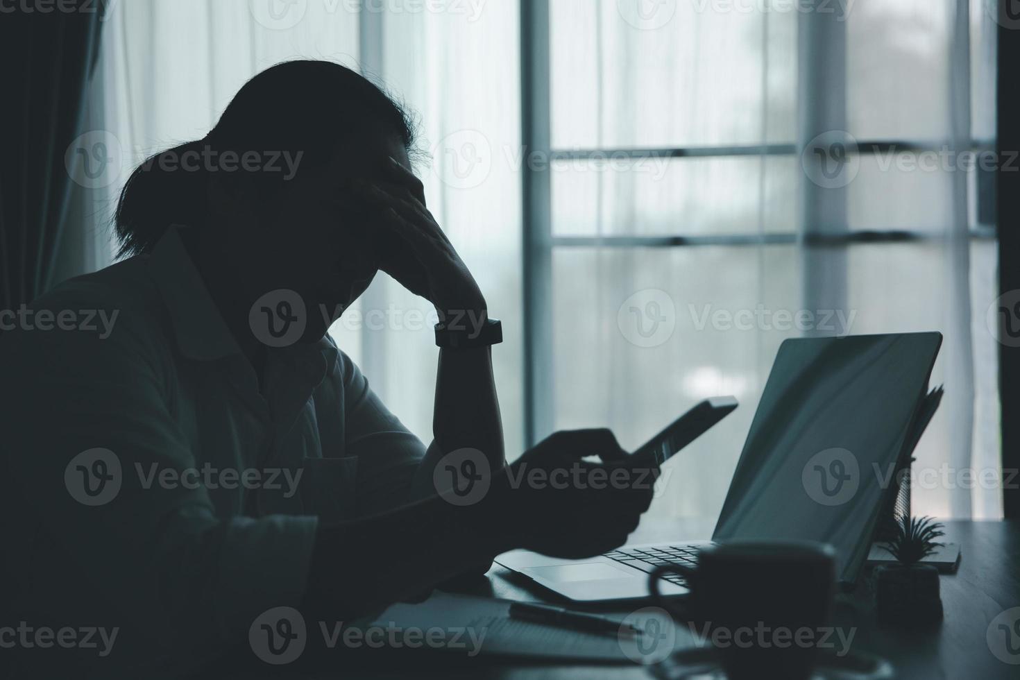 stress femme d'affaires personne de travail acharné, dépression au bureau. une employée fatiguée et anxieuse mécontente du travail problématique. jeune femme d'affaires triste assise devant un ordinateur portable sur le bureau. photo