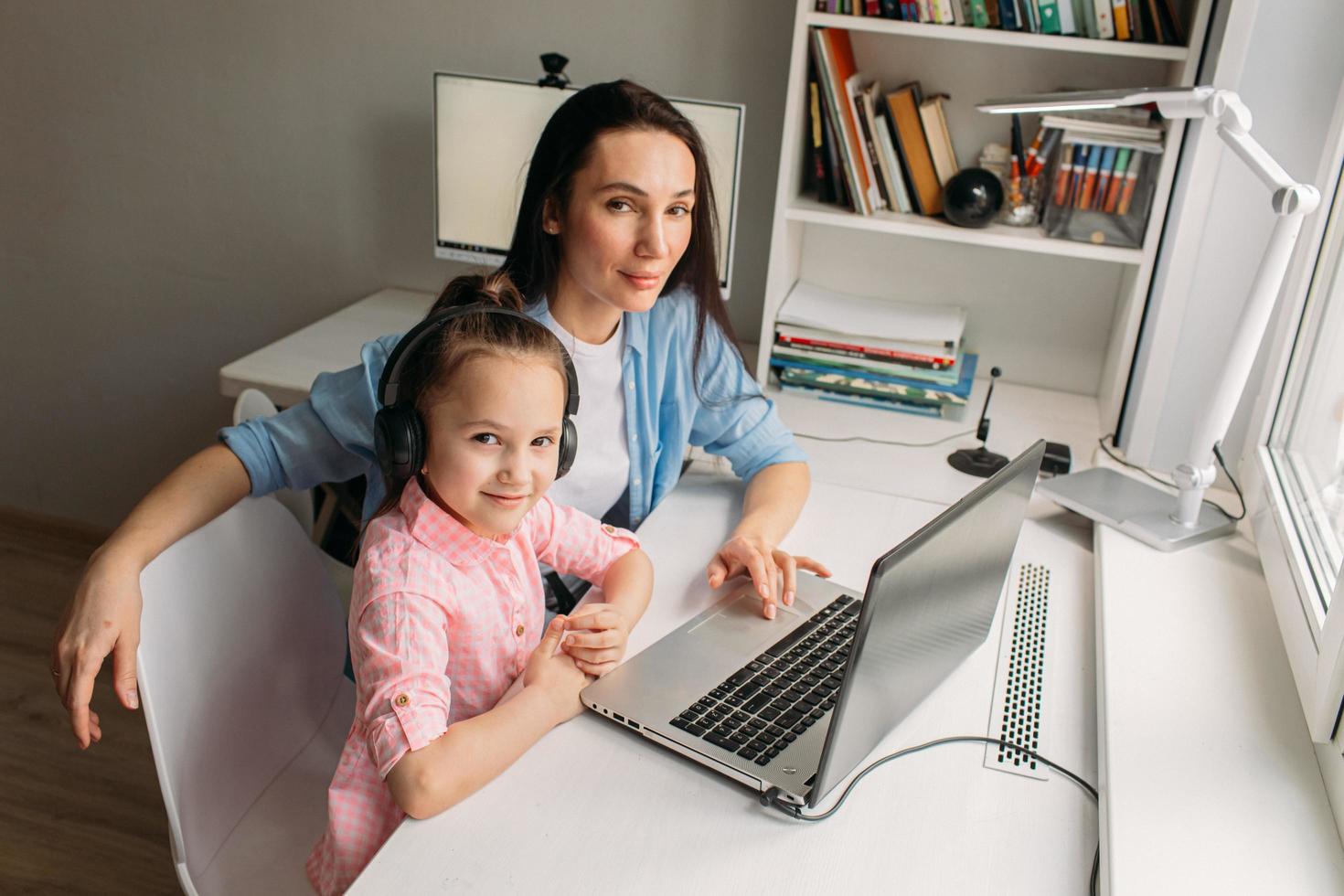 parent et enfant posant avec un ordinateur portable photo