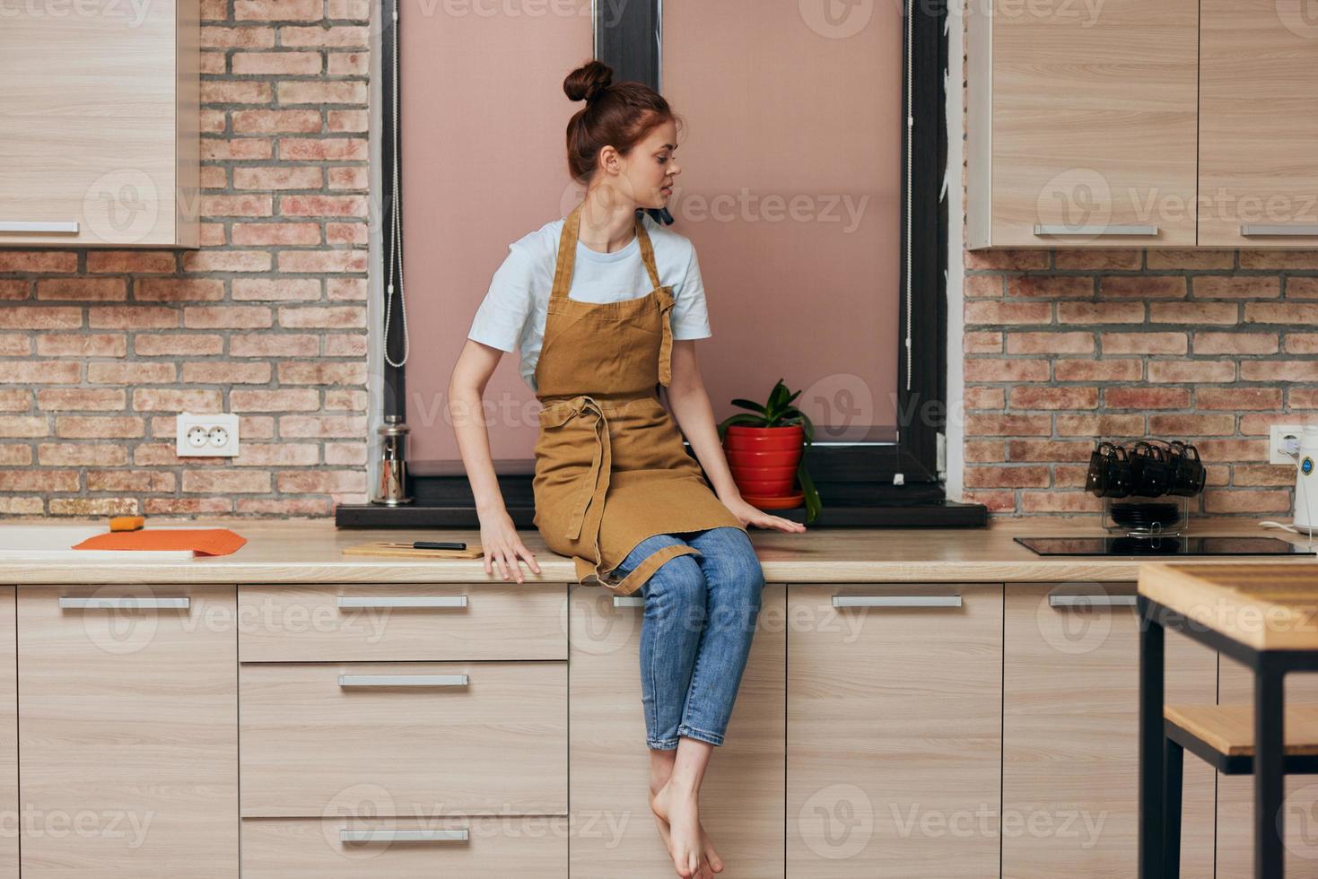 Jeune brunette femme sur cuisine compteur photo