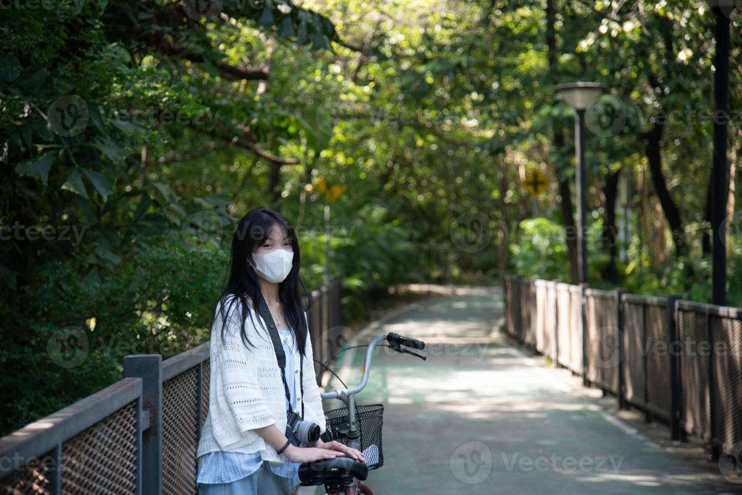 asiatique femme équitation une vélo dans le parc. photo