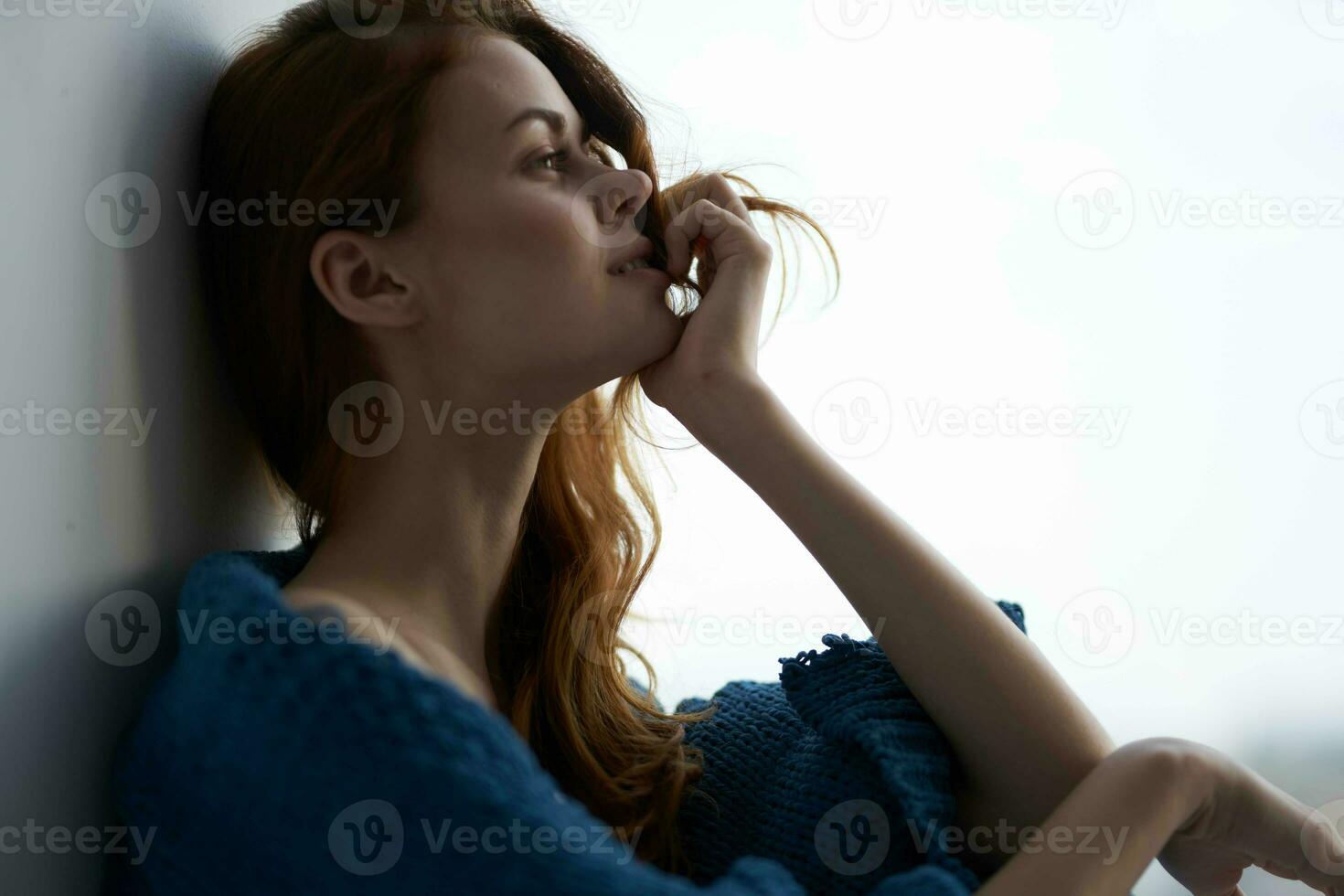 jolie femme séance près le fenêtre avec une bleu plaid Matin photo