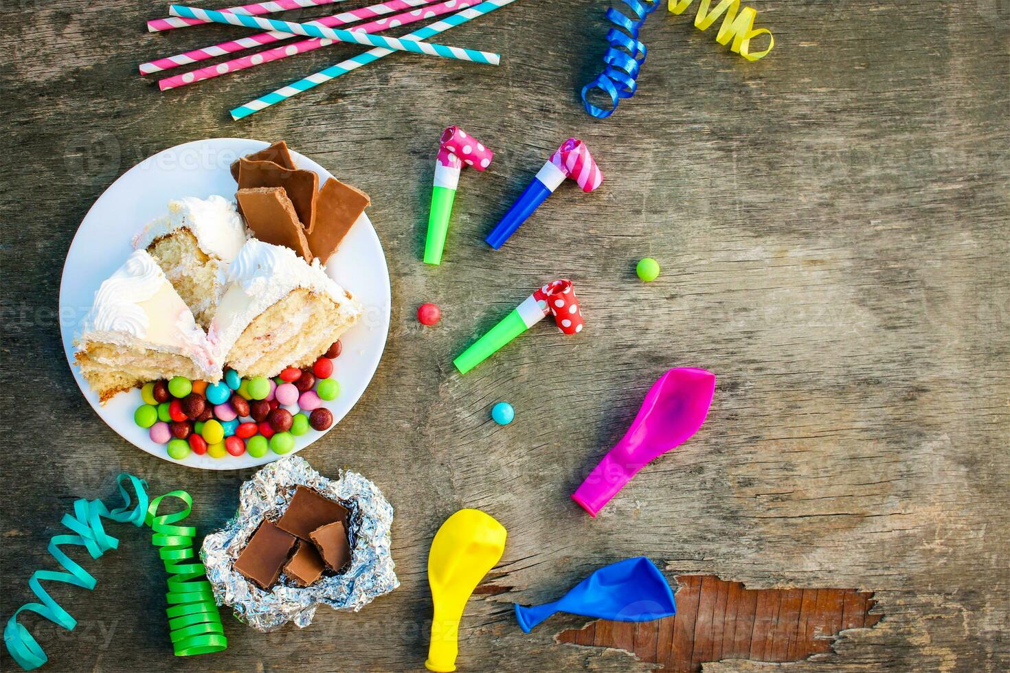 gâteau, bonbons, chocolat, sifflets, banderoles, des ballons sur vacances tableau. concept de enfants anniversaire faire la fête. vue Haut. photo