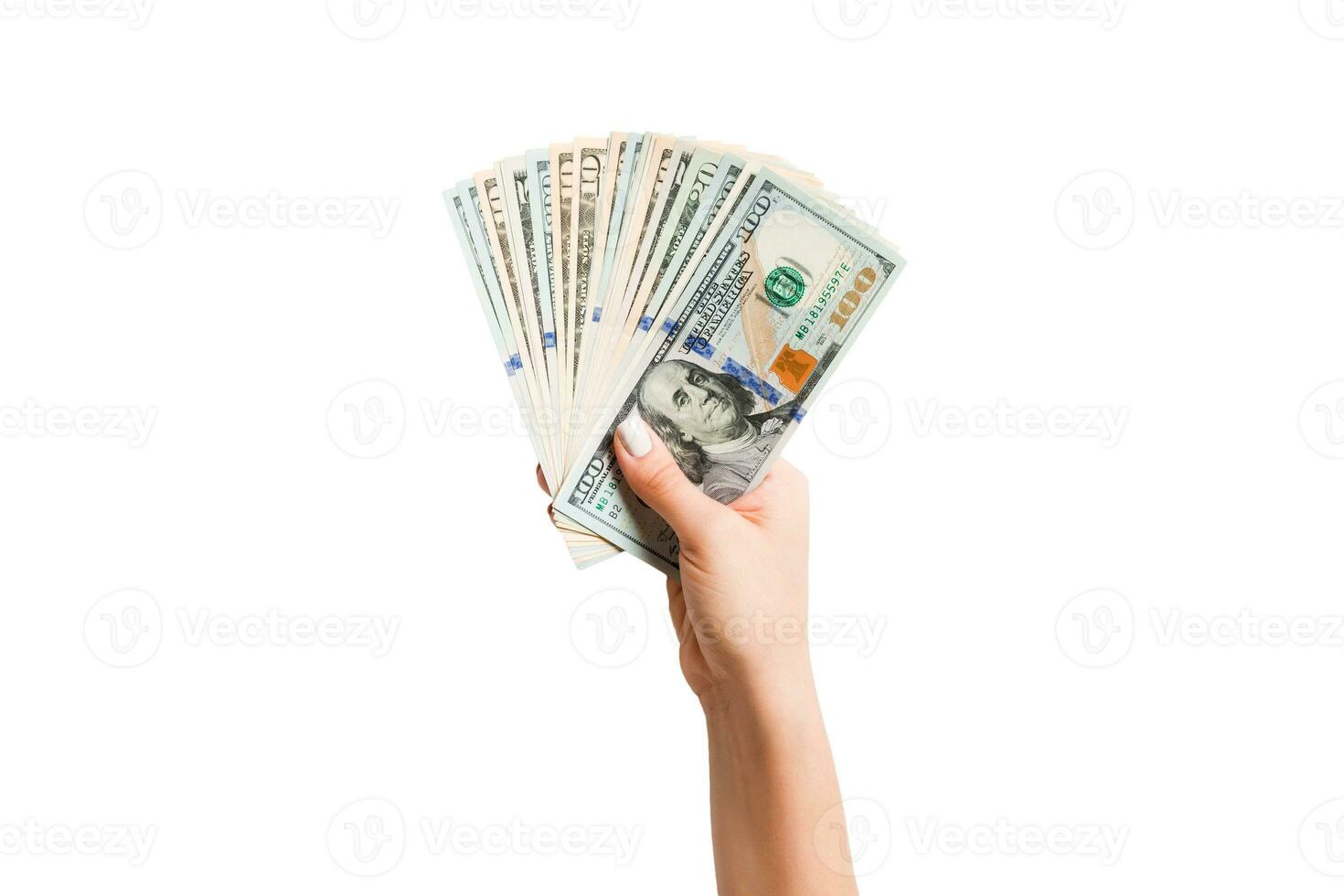 Haut vue de isolé femelle main en portant une ventilateur de différent dollar factures. richesse et riches concept photo