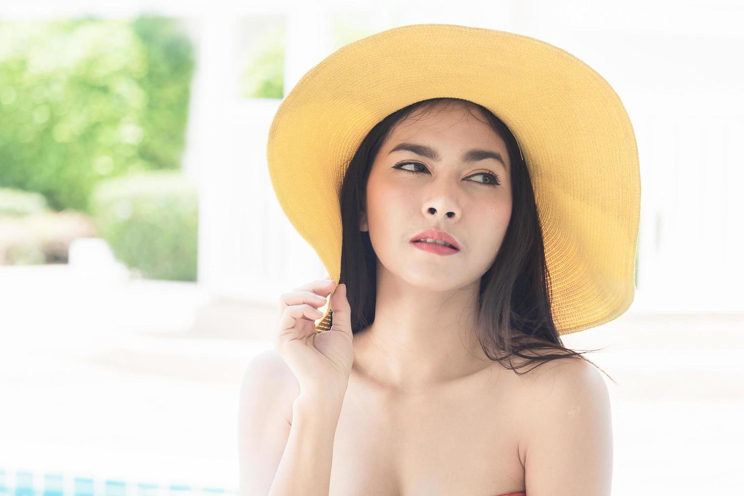 Portrait d'une belle femme asiatique portant un chapeau jaune photo