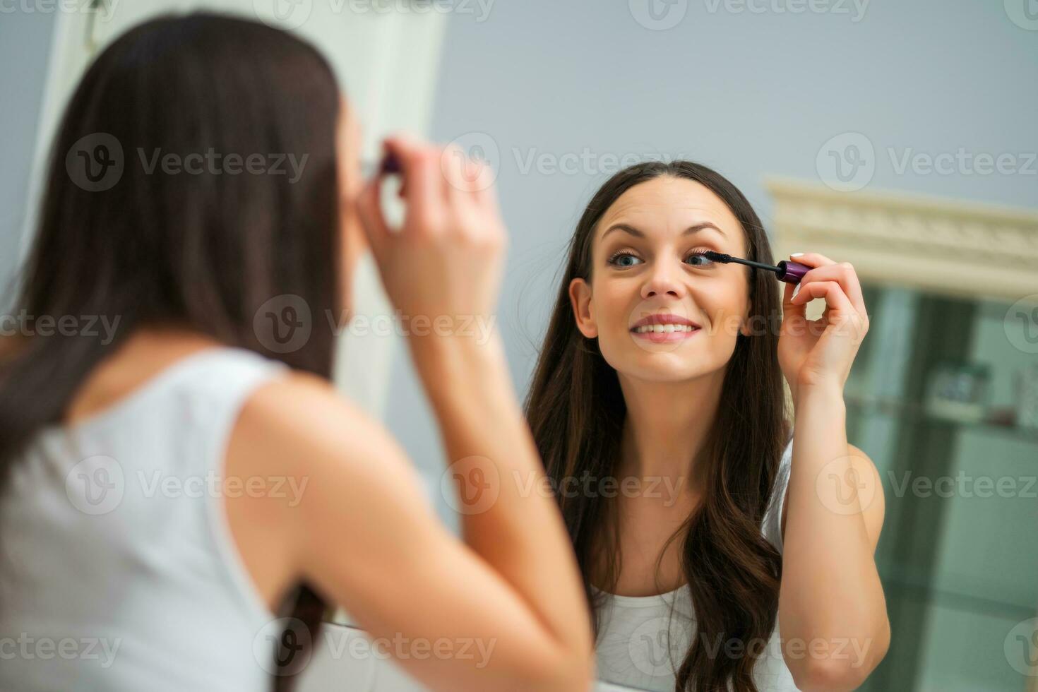 une femme qui met sur maquillage photo