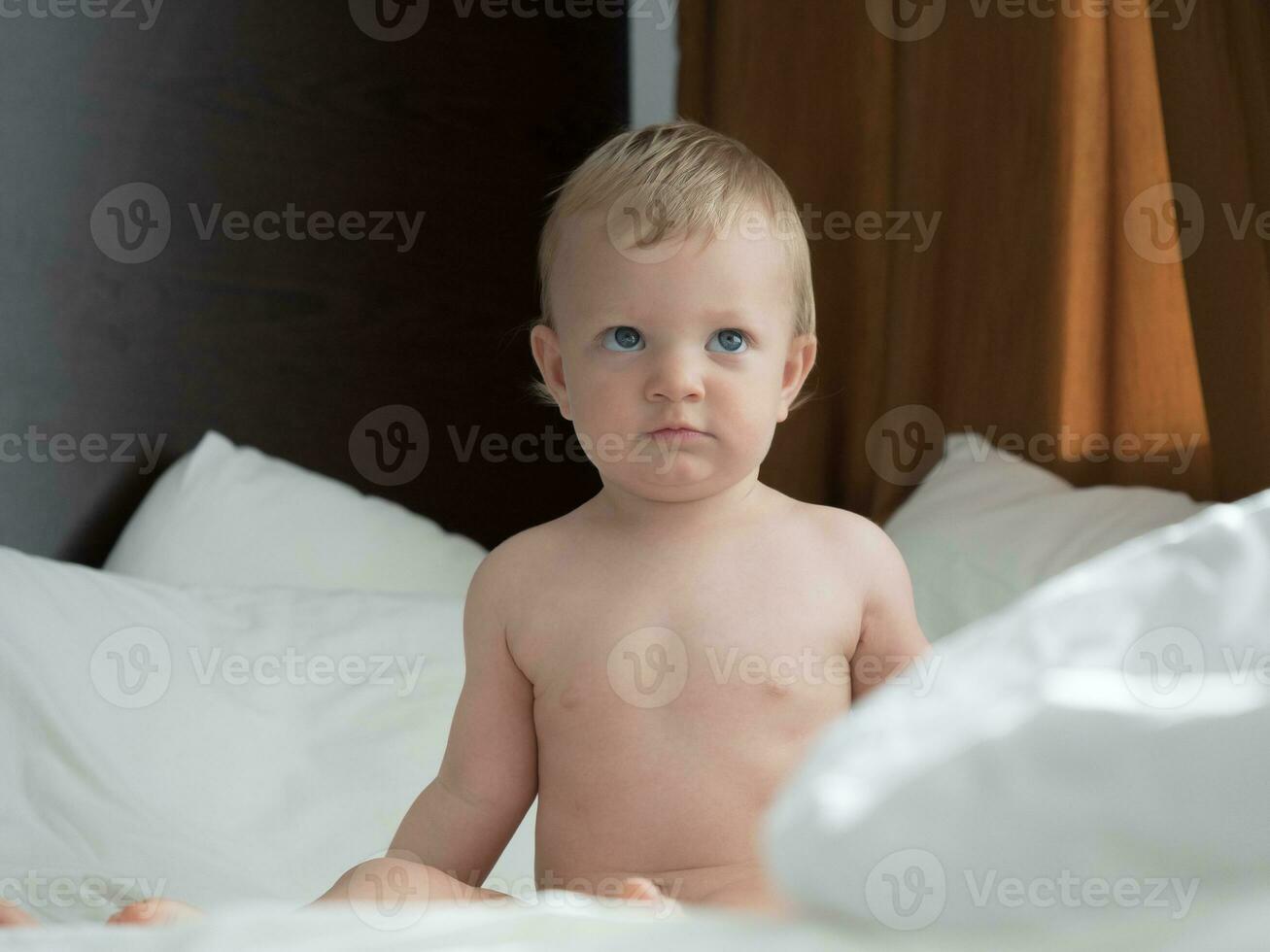 bébé séance sur le lit et à la recherche photo