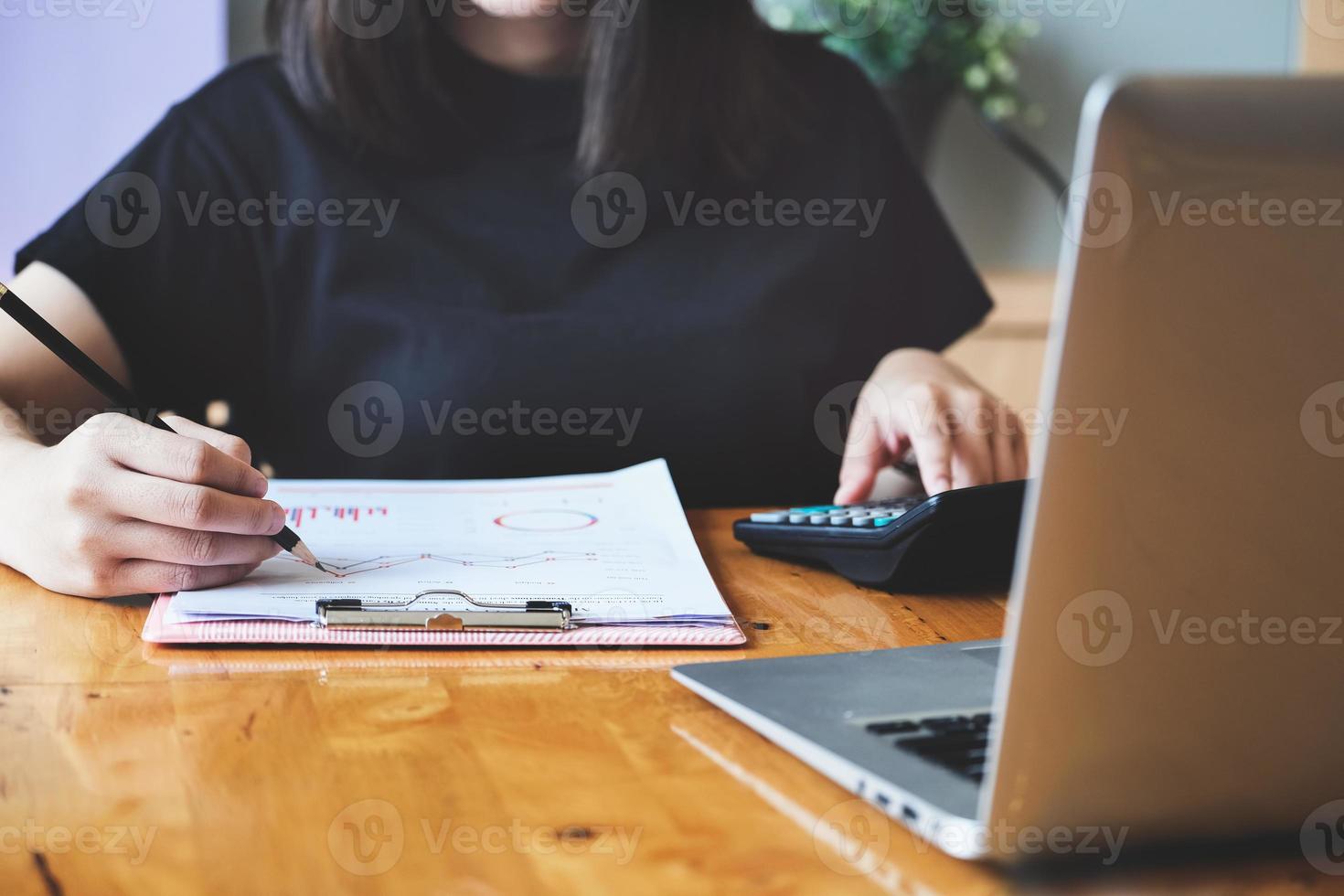 femme d'affaires à l'aide de la calculatrice pour examiner le bilan photo