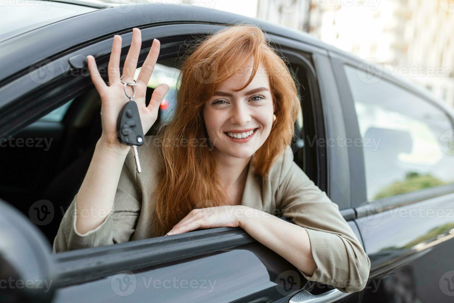 Jeune femme souriant montrant sa Nouveau voiture clés, clés à sa de location auto. photo