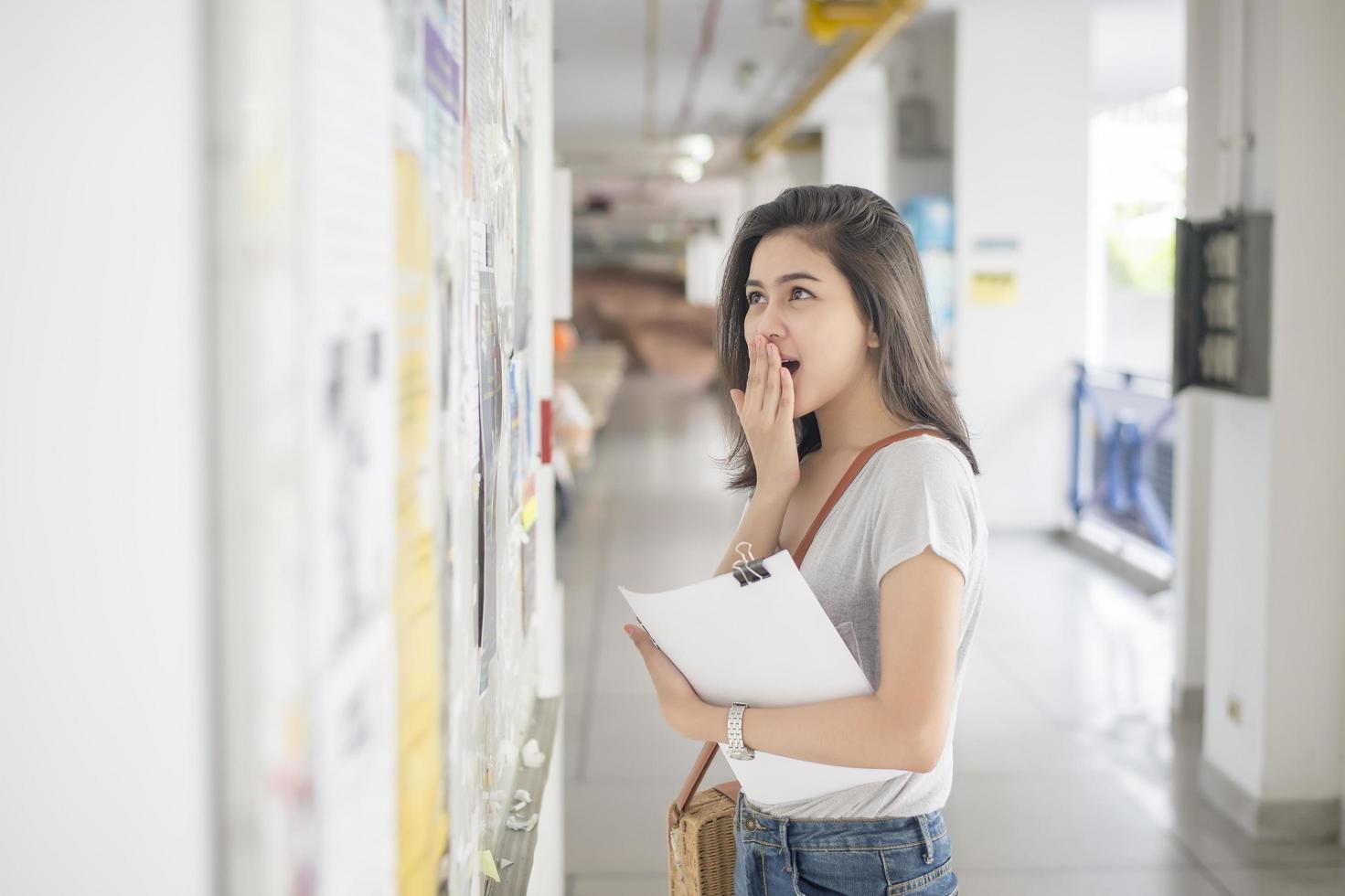 une étudiante universitaire est passionnante avec le rapport d'examen photo