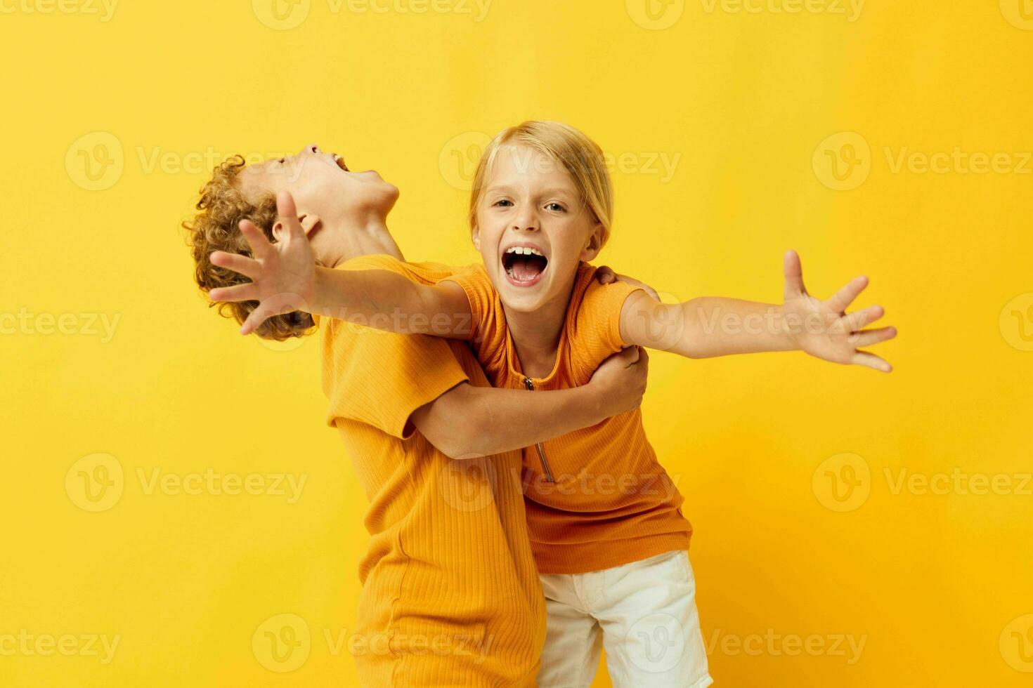 deux joyeux les enfants câlins mode enfance divertissement sur coloré Contexte inchangé photo