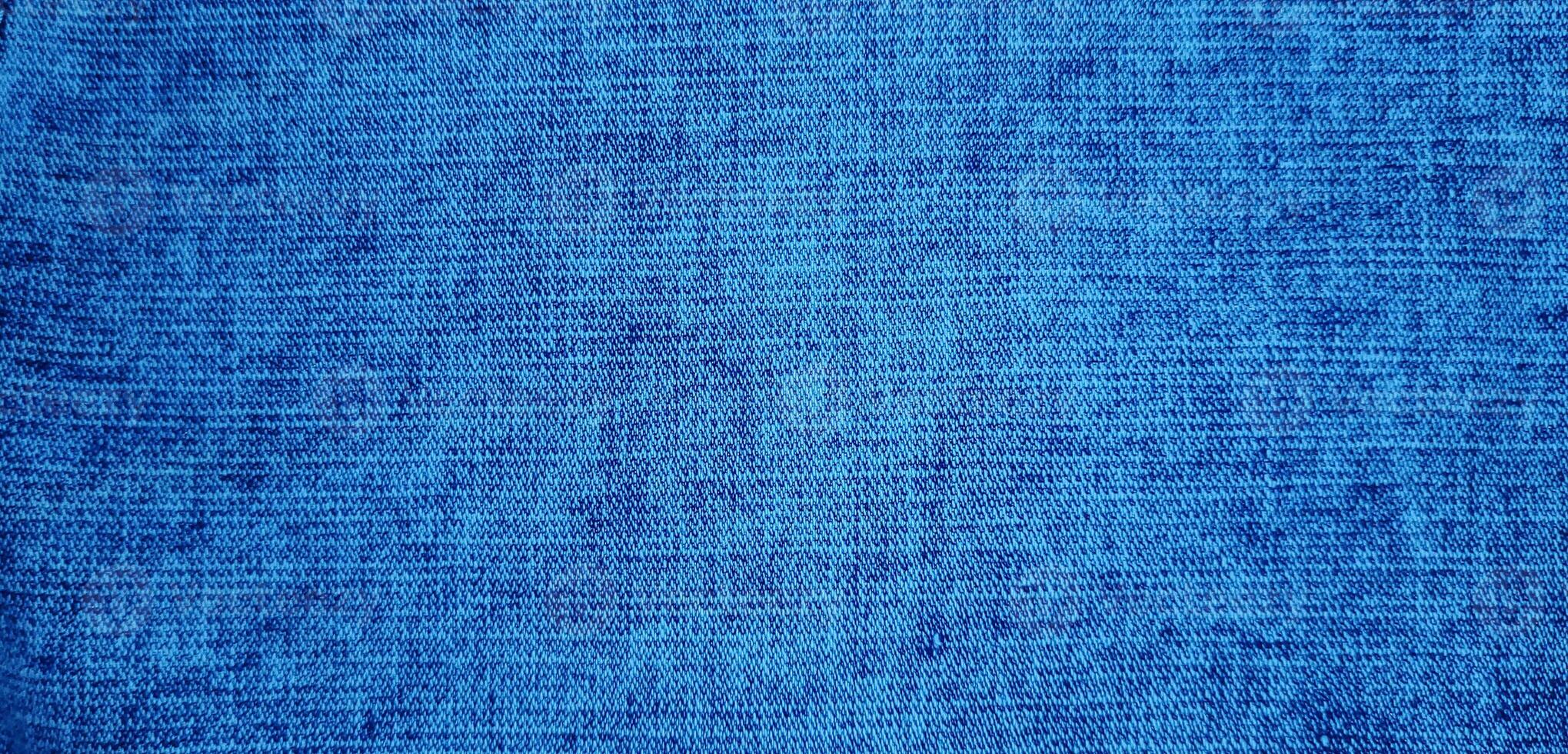 lumière bleu Couleur abstrait denim veste, ancien denim jeans tissu et en tissu proche en haut macro photo pour Contexte