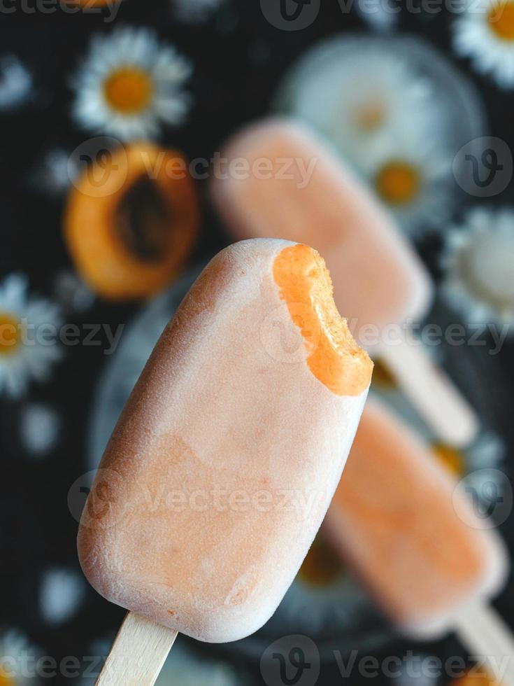 crème glacée maison sur un bâton d'abricots et de yaourt. concept d'alimentation saine photo