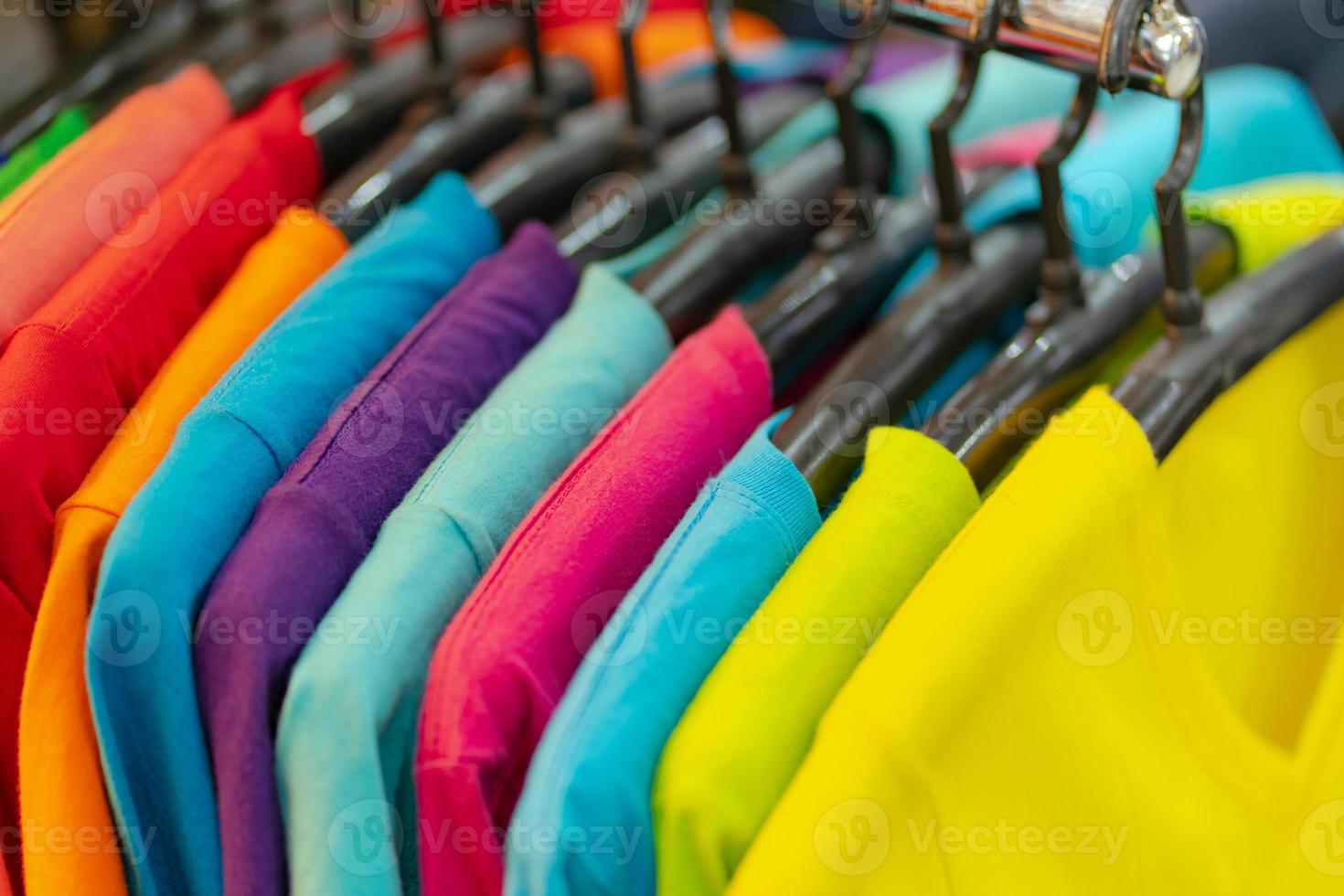 gros plan de t-shirts colorés sur des cintres photo
