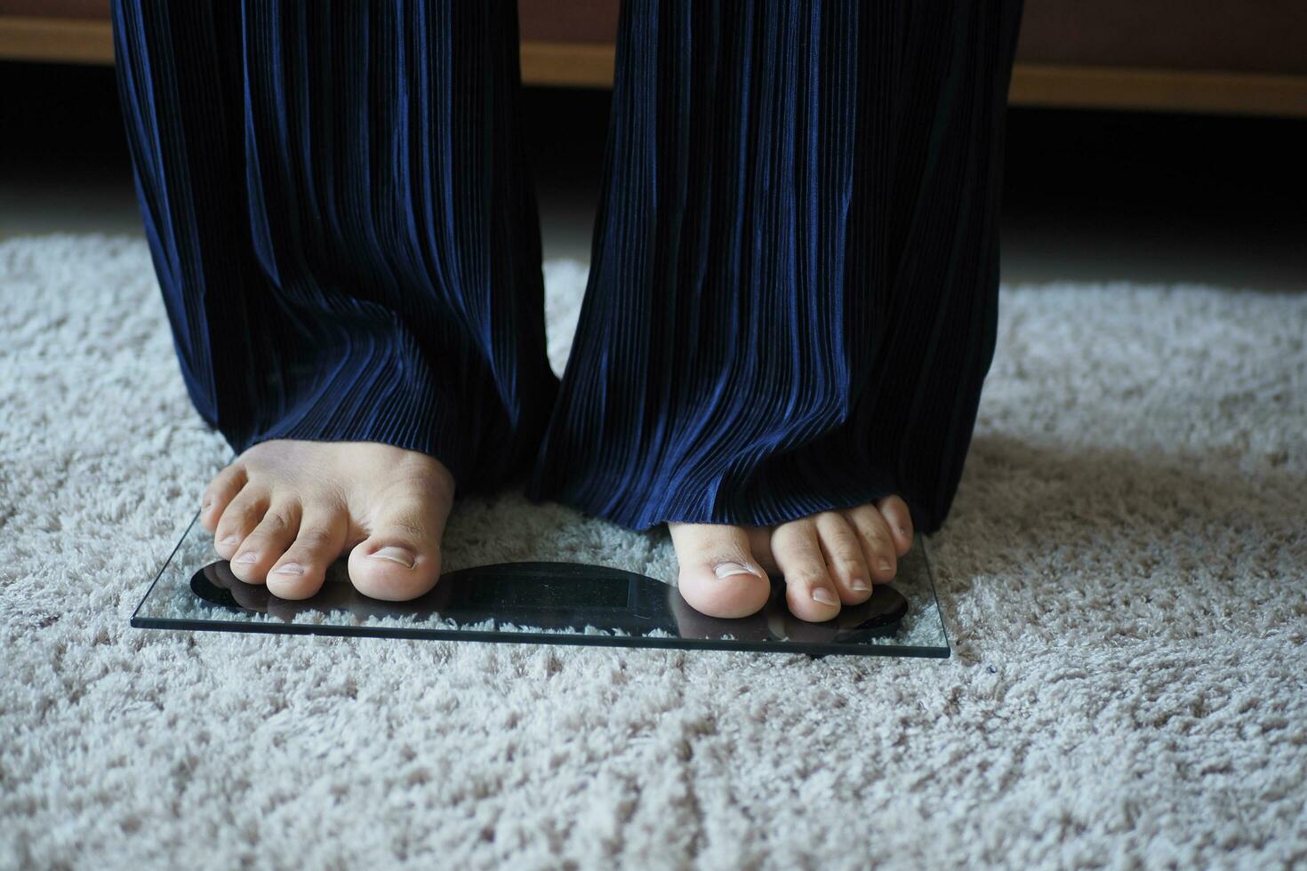 femme pieds sur poids échelle proche en haut. photo