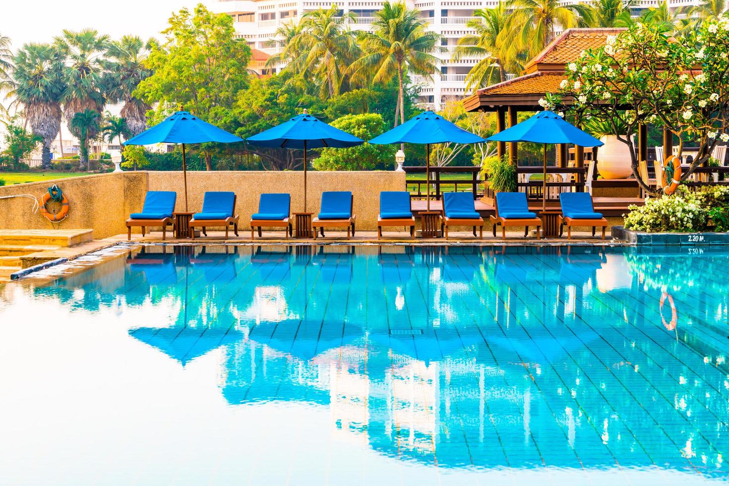 beau parasol et chaise autour de la piscine de l'hôtel et du complexe photo