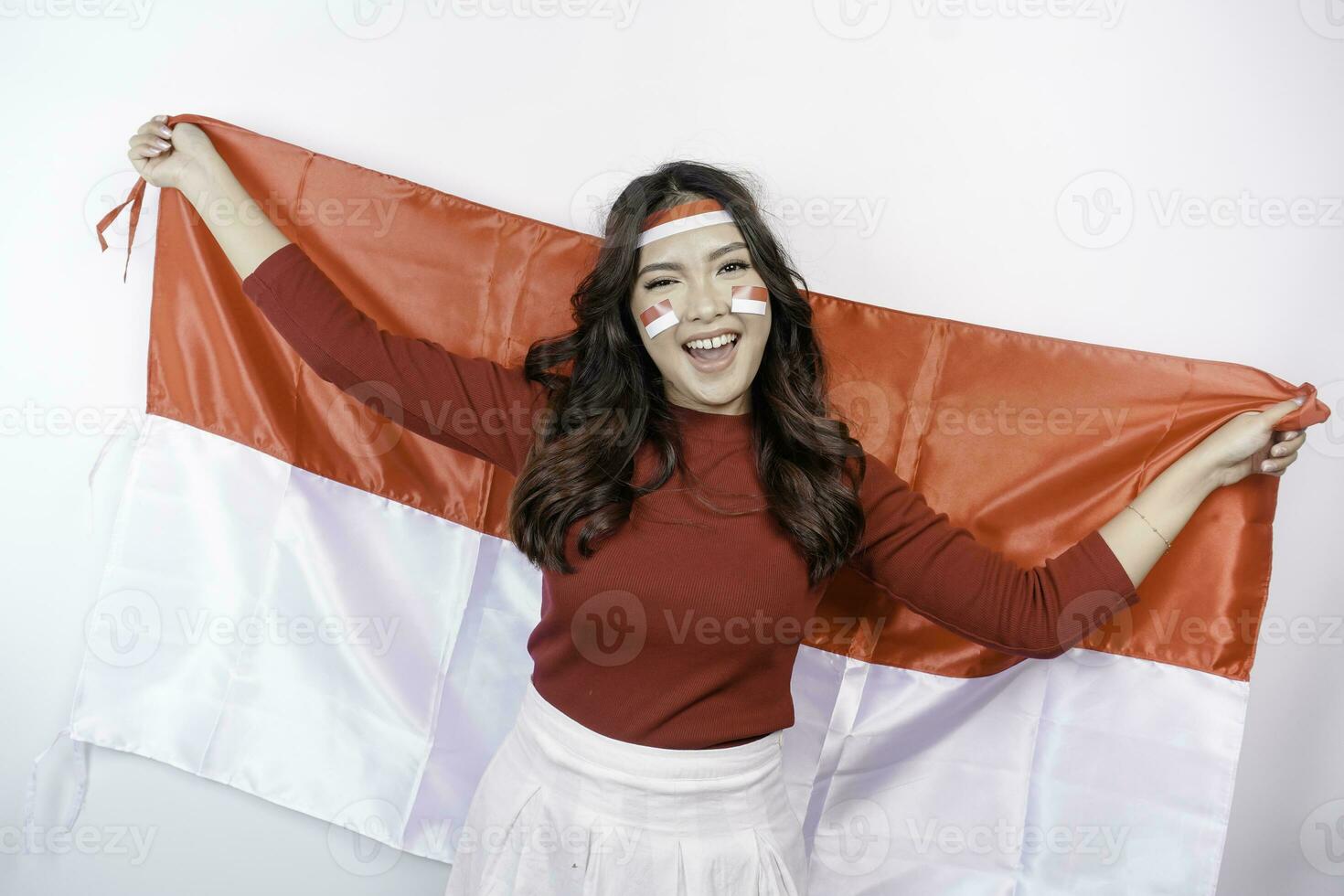 content souriant indonésien femme en portant l'indonésie drapeau à célébrer Indonésie indépendance journée isolé plus de blanc Contexte. photo